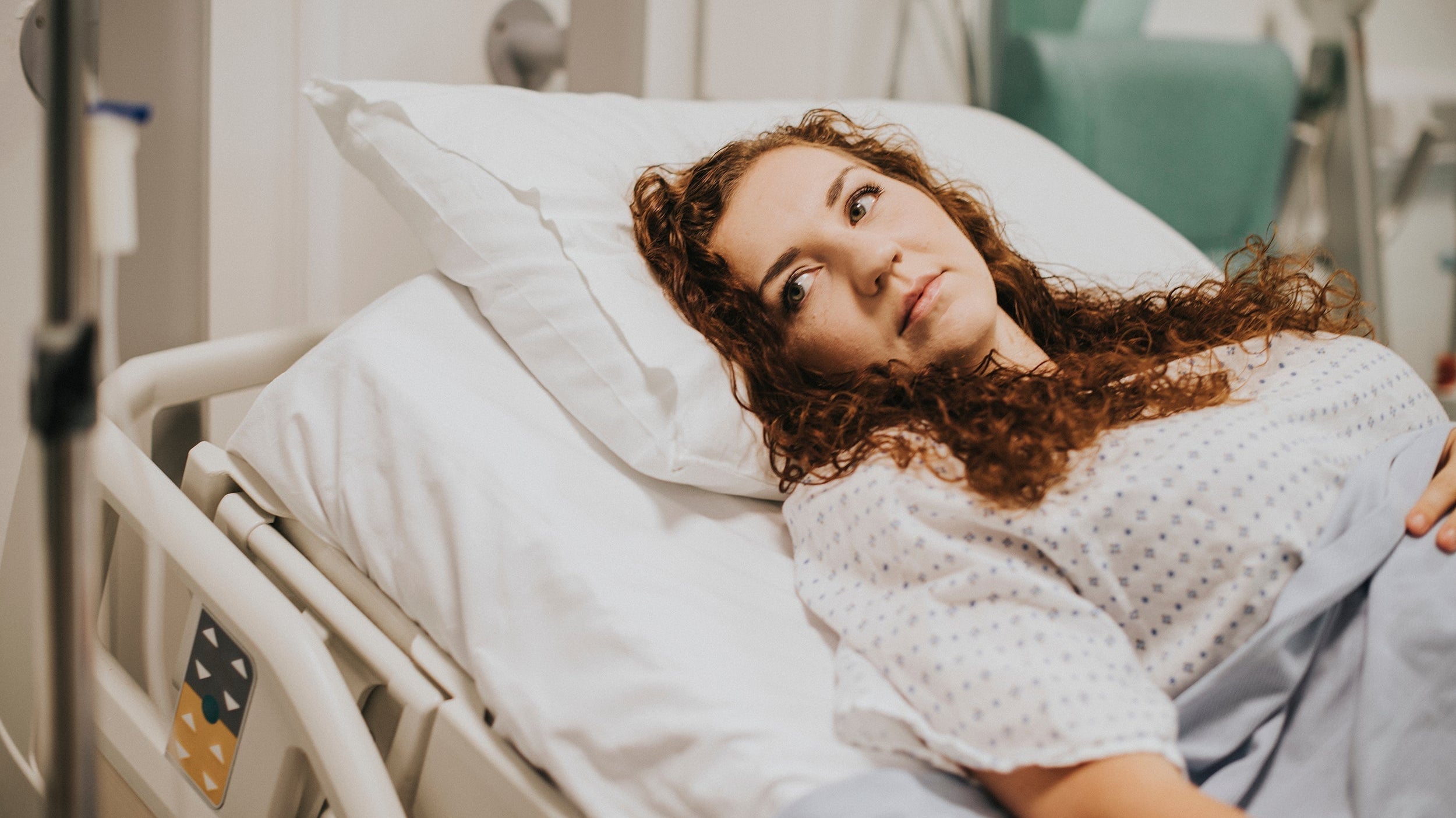 A woman lies in bed following surgery. If you're preparing for gallbladder surgery, be sure to check out our complete guide on how to sleep after gallbladder surgery and get the rest and recovery you need and deserve.