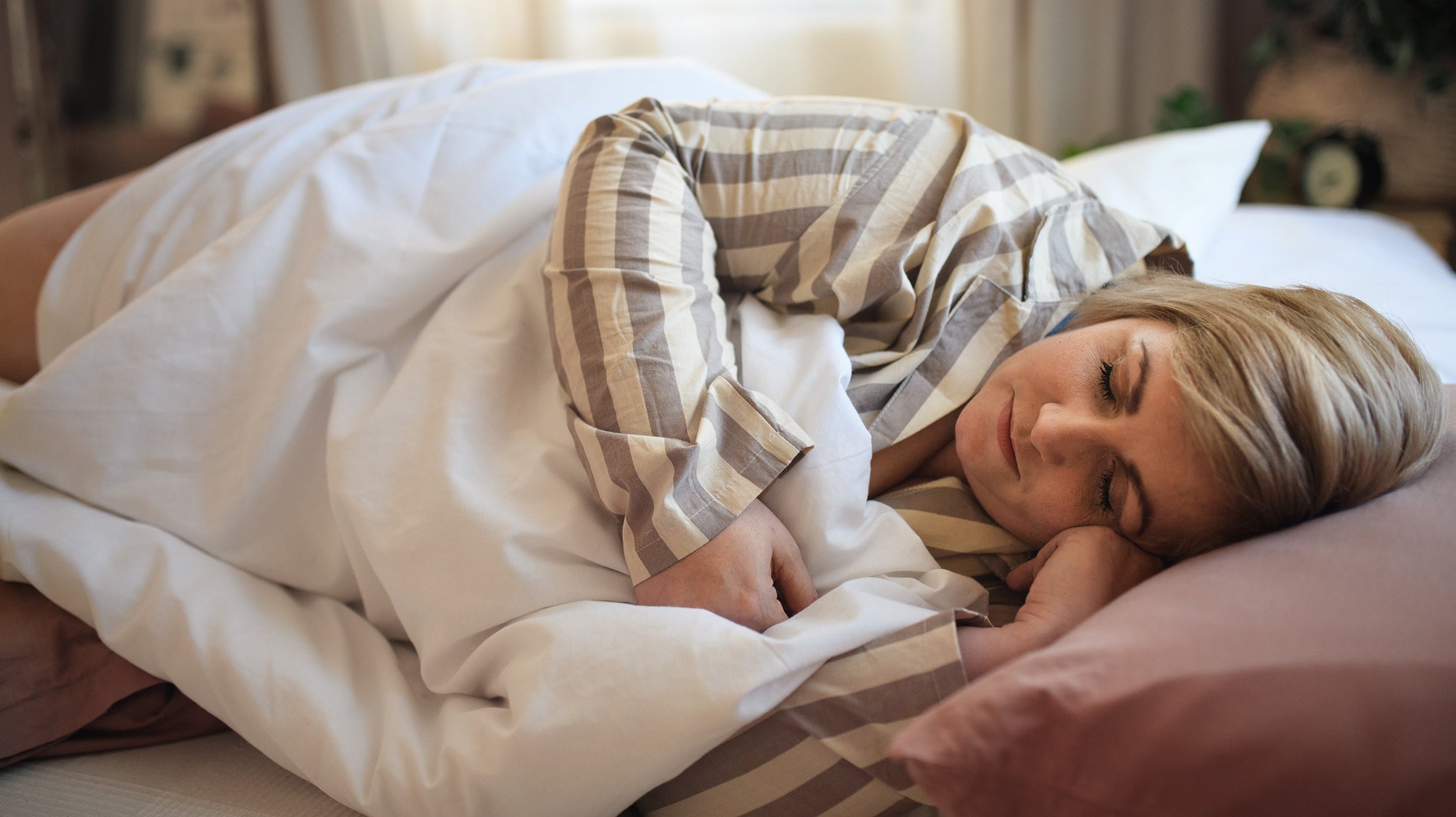 A woman sleeping. Panniculectomy recovery starts with sleep positioning. Learn the surgeon-recommended setup in our complete guide.
