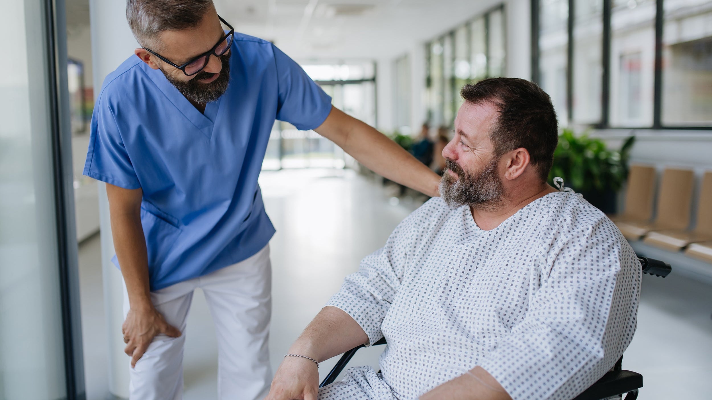 A doctor talks to a patient awaiting surgery. Learn how to sleep after gynecomastia surgery before your procedure date. Elevation angle, positioning timeline, and what to set up in advance.