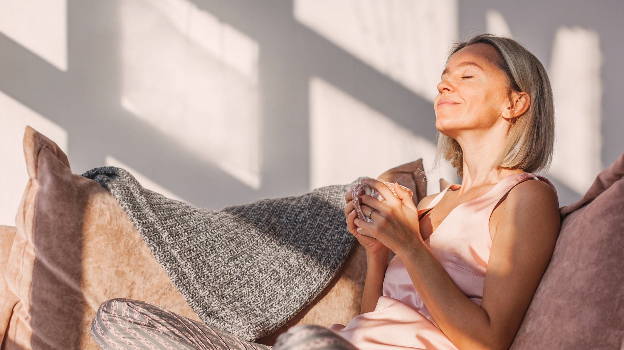 A woman breathes deep while enjoying a morning coffee. Learn how sleeping at a 30-degree angle improves digestion, breathing, circulation & pain. Science-backed benefits plus practical setup guidance.