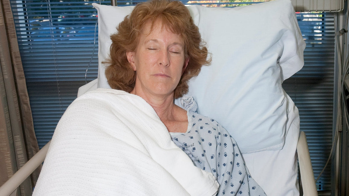 Woman sleeping at an elevated angle after surgery.