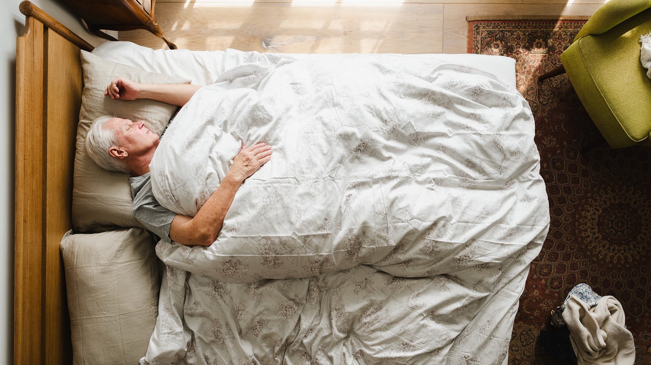 A man sleeping in bed. Sleep is when your body actually heals after surgery. Here's why it matters, what disrupts it, and how to set up your recovery sleep before surgery day itself.