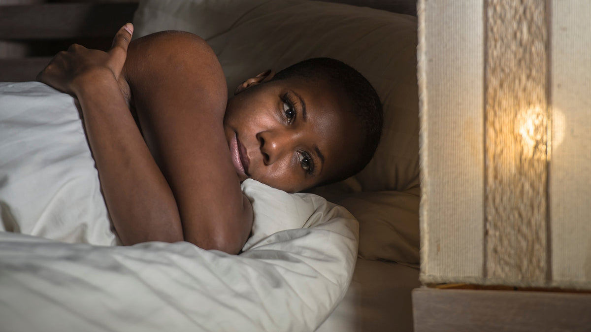 A woman struggling to sleep. Cancer treatment can disrupt sleep through surgical pain, medication side effects, and hot flashes. See the common causes and practical ways to sleep better.