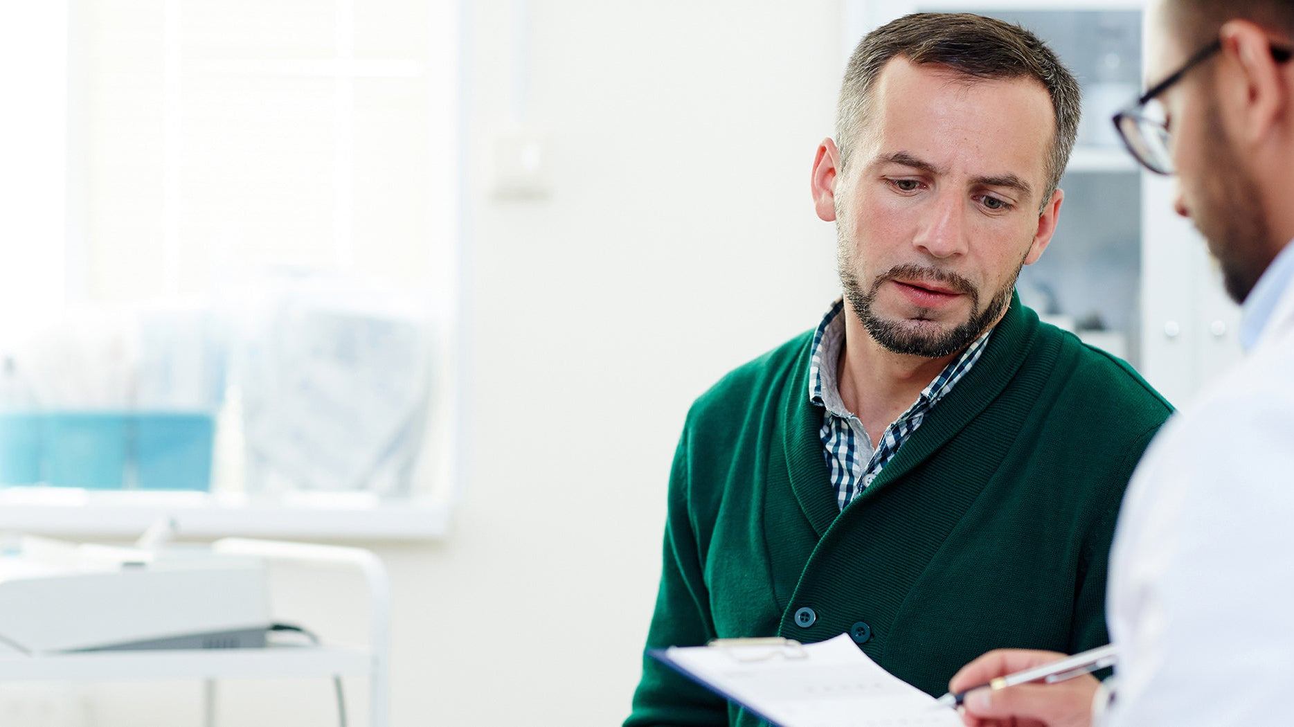 A man talks to his doctor. Most colorectal surgery patients aren't ready for recovery sleep. Here's the positioning guide and setup checklist to have in place before you come home.