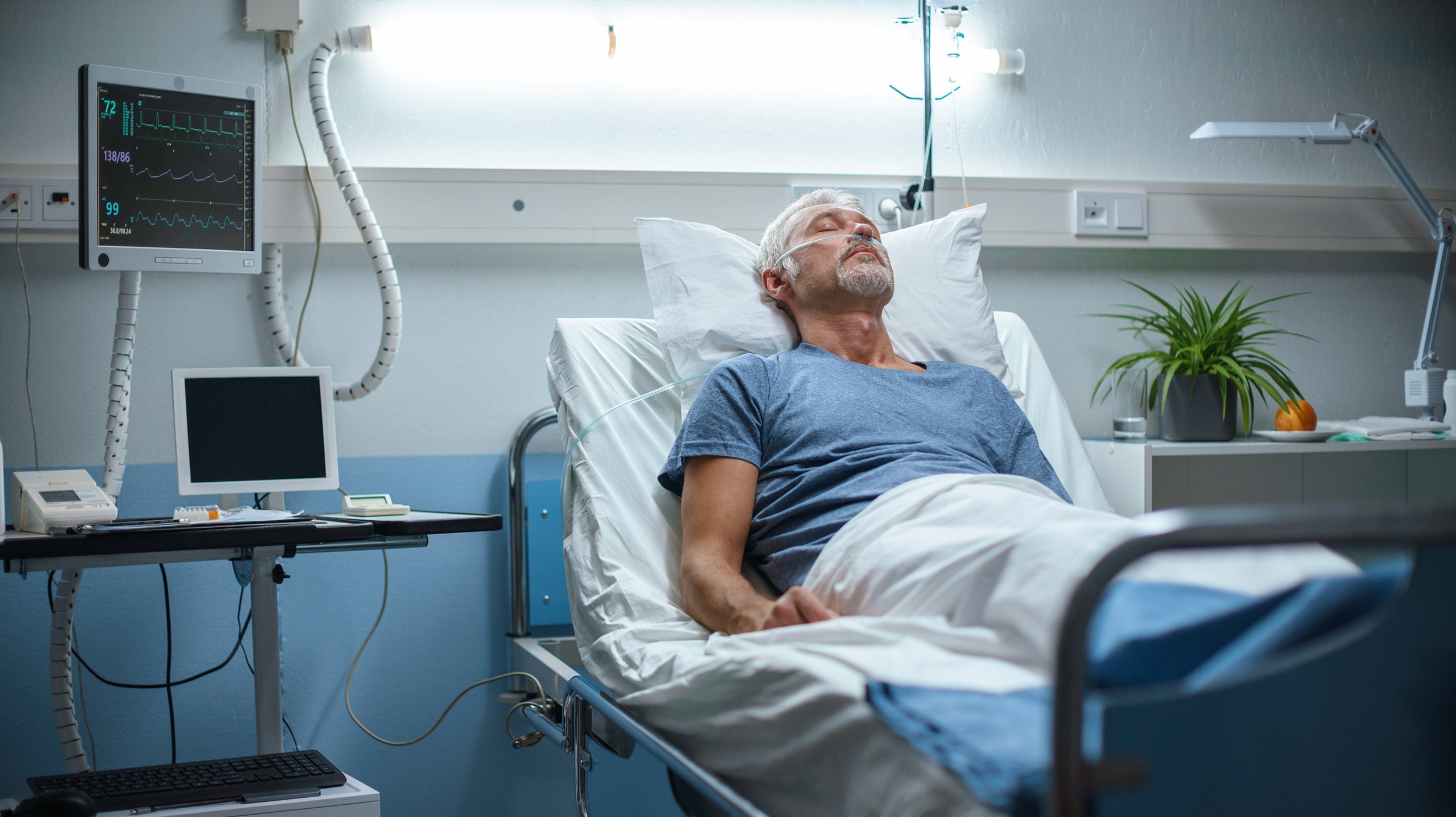 A man rests in a hospital bed. Learn how to sleep after rotator cuff surgery with our complete guide and protect your recovery from night one.