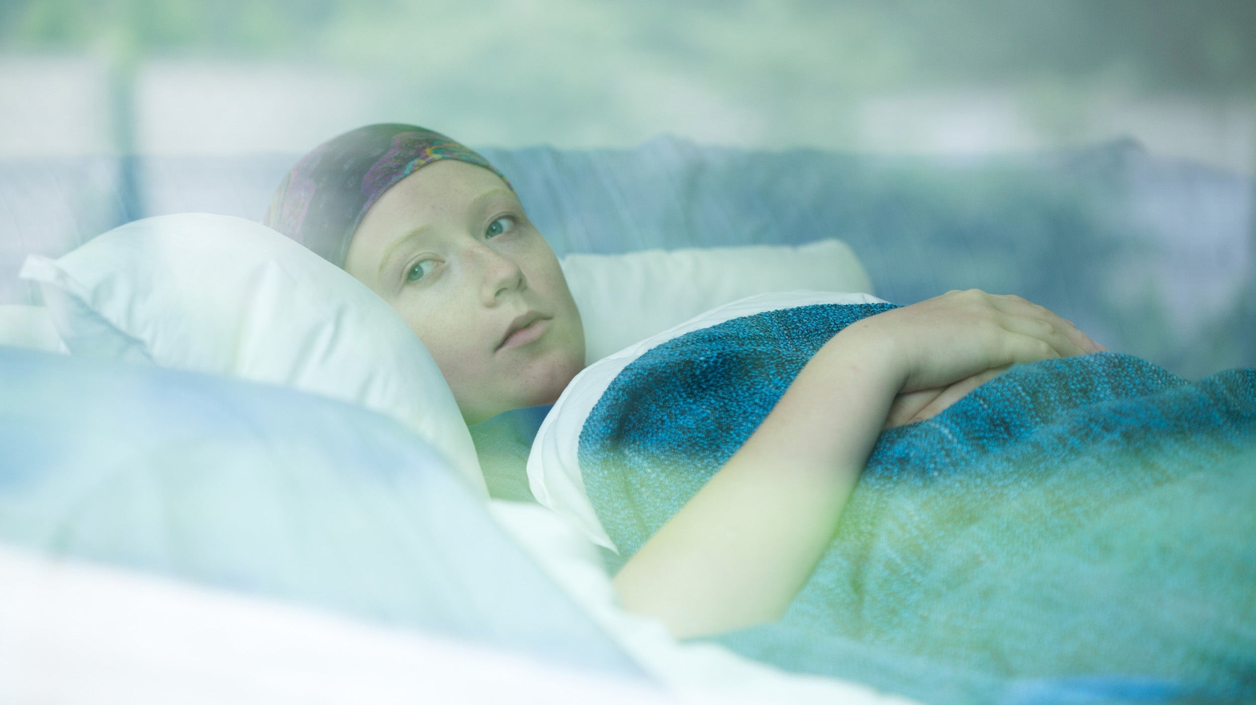 A woman with cancer rests in bed. Struggling to sleep during cancer treatment? Learn when to seek professional support and which bedtime habits can truly improve your sleep quality."