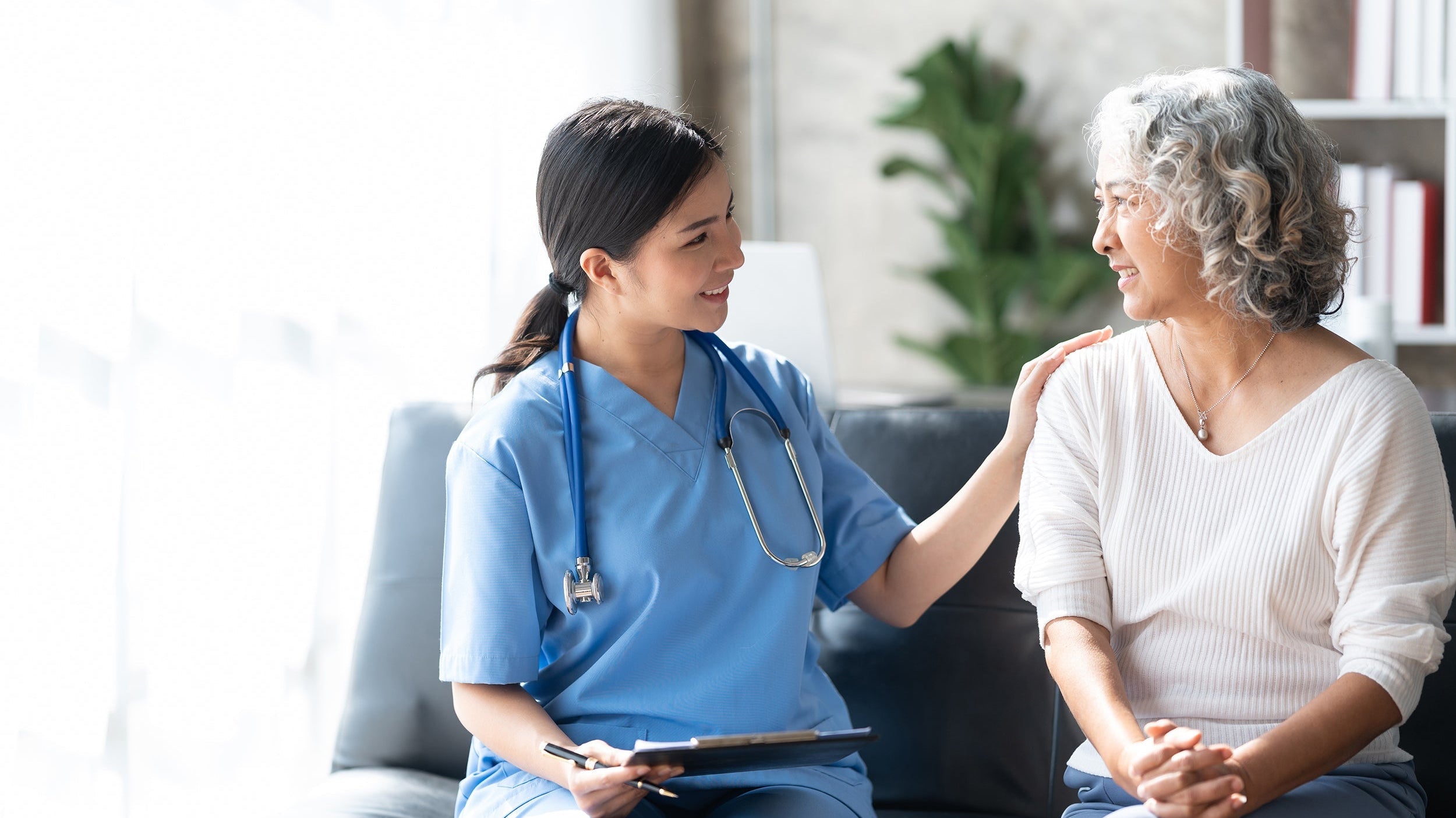 A physician comforts a patient. Get the healing rest your need and deserve in our complete guide on how to sleep after a hysterectomy.