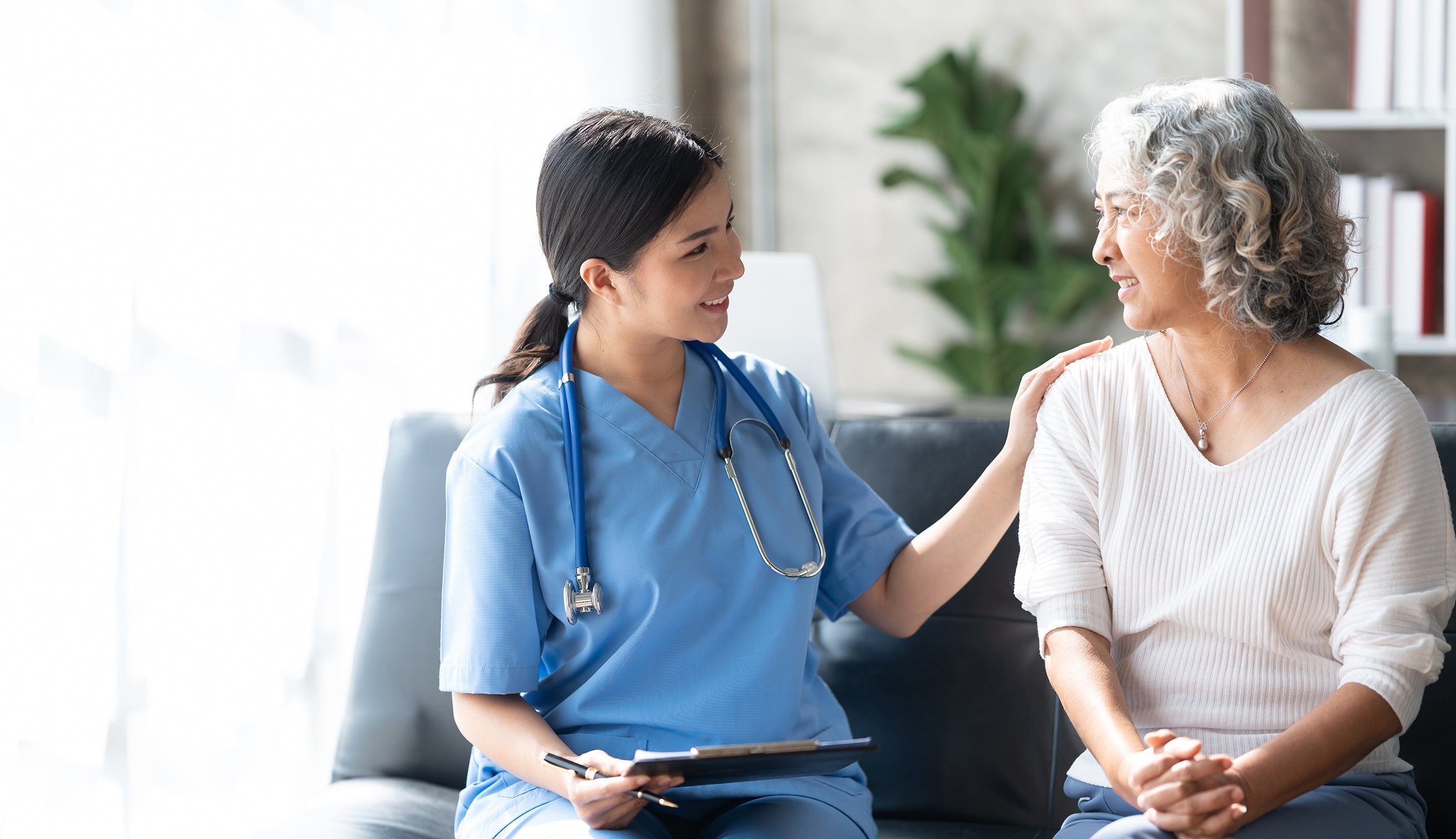 A physician comforts a patient. Get the healing rest your need and deserve in our complete guide on how to sleep after a hysterectomy.