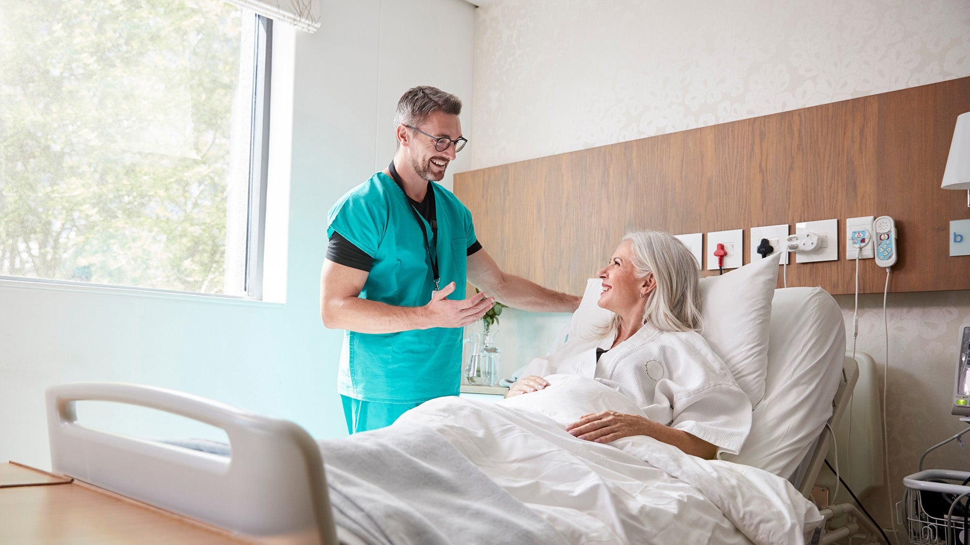 A doctor talks to a patient. Planning skin removal surgery recovery? Learn what sleep positions, timelines, and setup you need before surgery day—not after.
