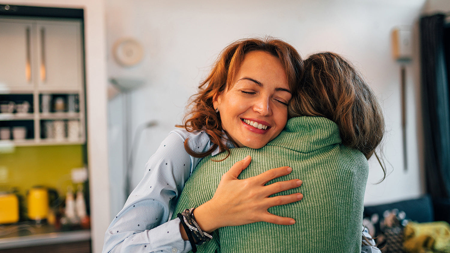 Two women hugging. Planning a gift for someone having cosmetic surgery? These 10 picks help with real recovery needs, starting with the system built for better sleep positioning.