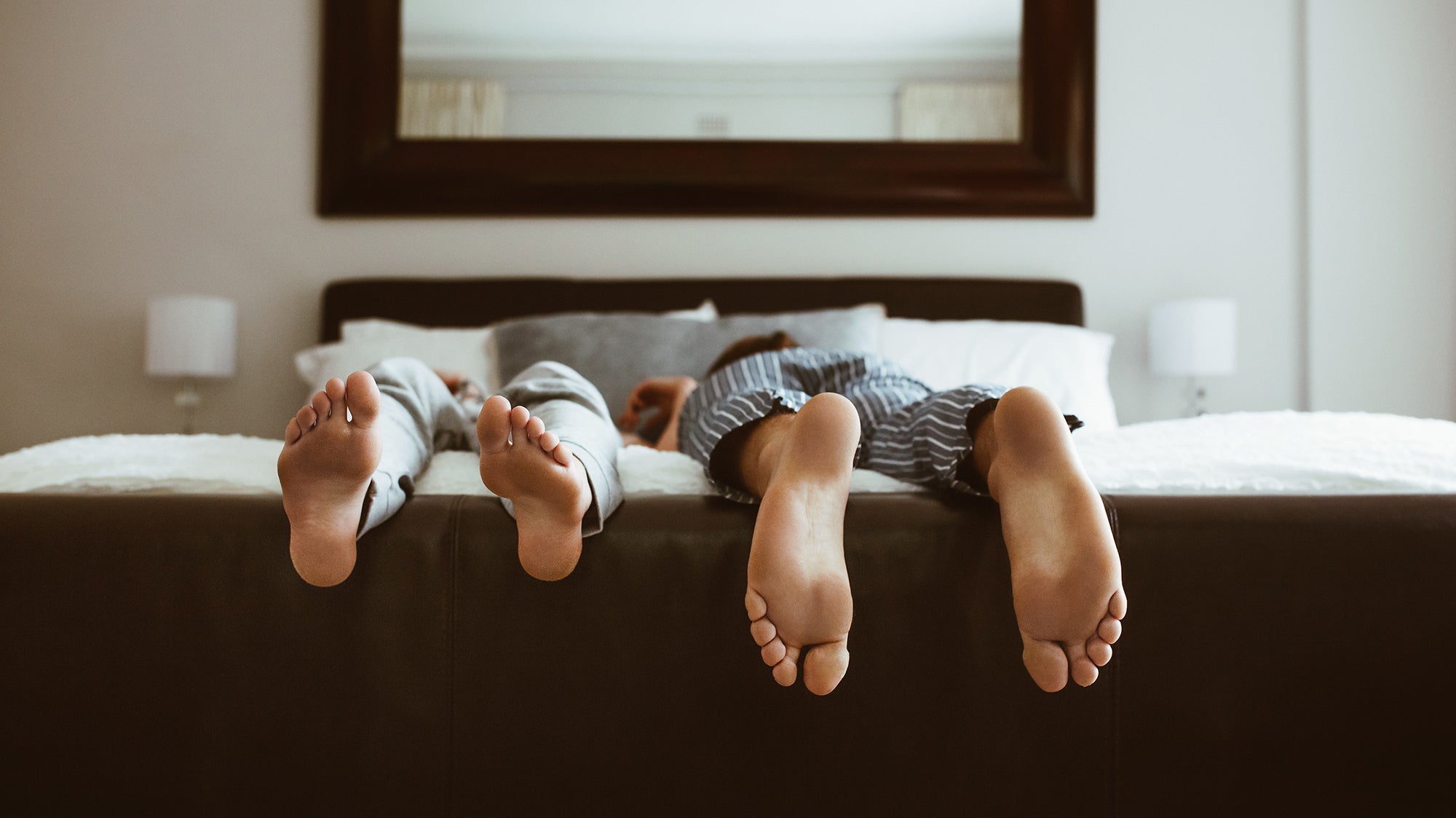 Two people sleeping in different positions. Back, side, stomach, or elevated—every sleep position affects your spine, breathing, and comfort differently. Compare the real pros and cons of each.