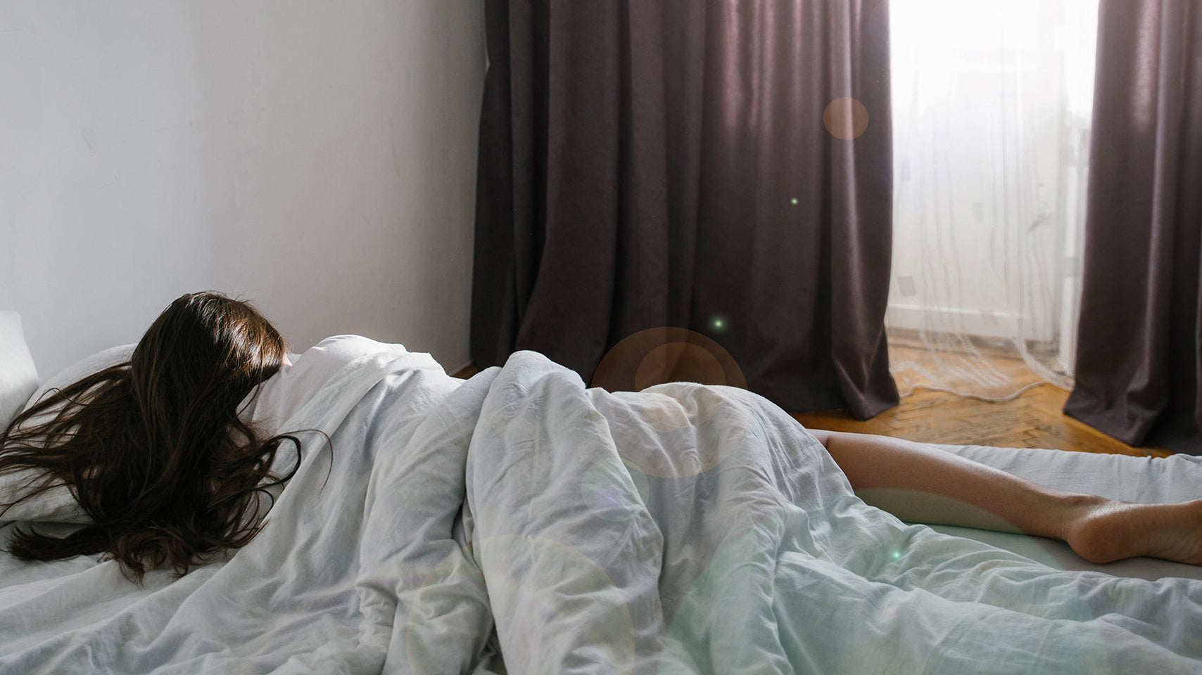 A woman sleeping on her side. Facelift recovery sleep guide: when side sleeping is safe again, why elevation matters for swelling, and how to set up positioning before your surgery day.