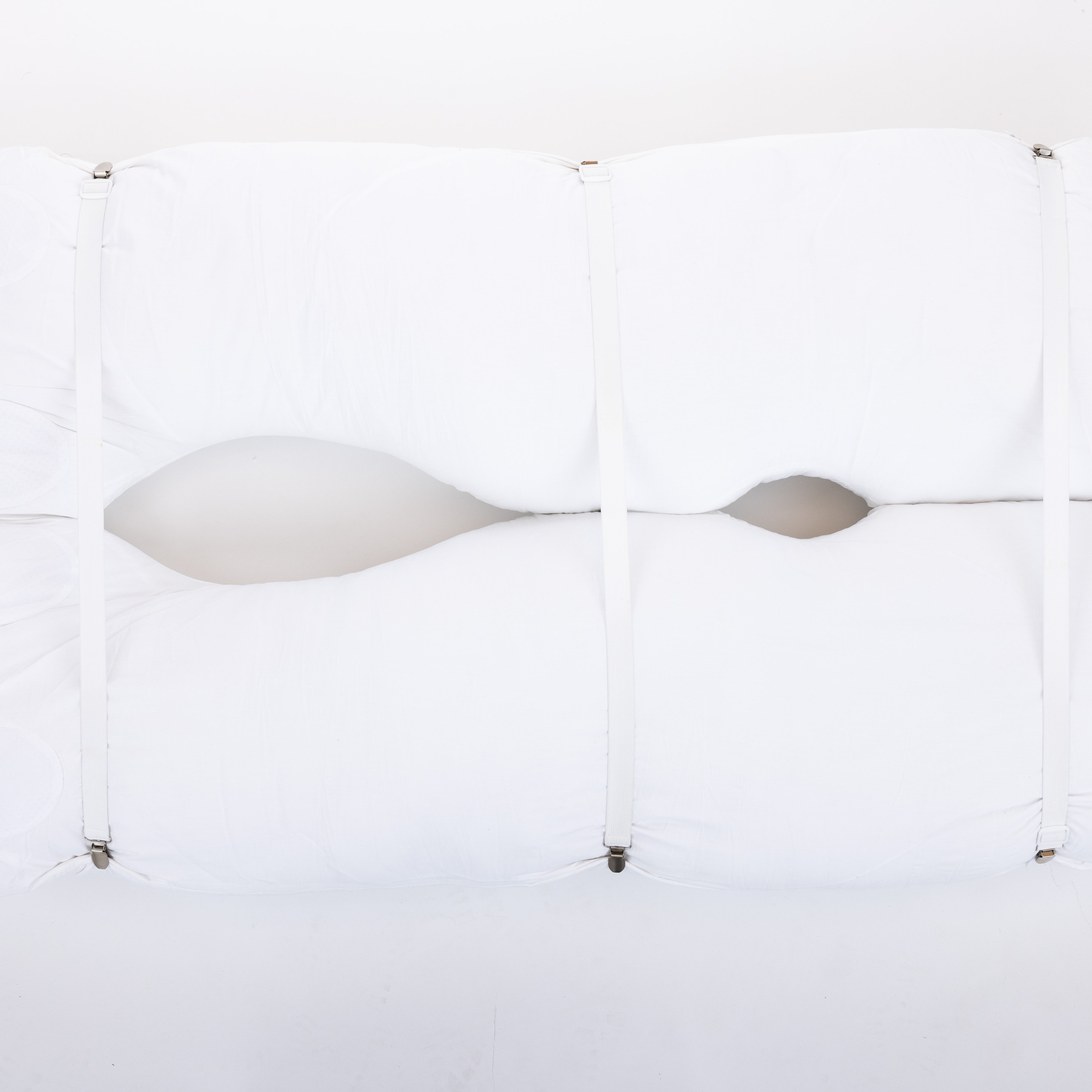 Four white pillow straps with clasps, displayed against a white background, arranged parallel to each other with clasps facing the same direction.