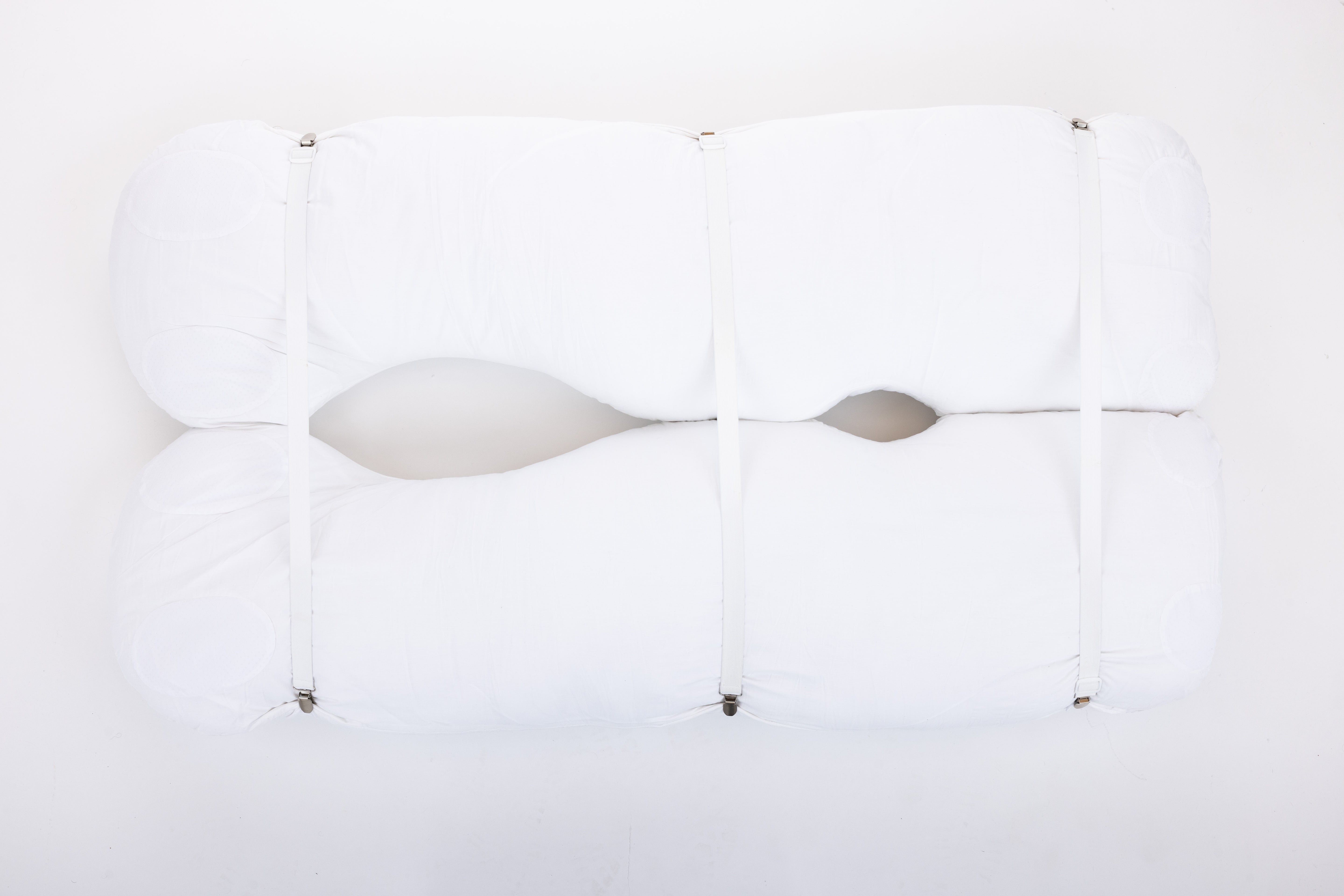 Four white pillow straps with clasps, displayed against a white background, arranged parallel to each other with clasps facing the same direction.
