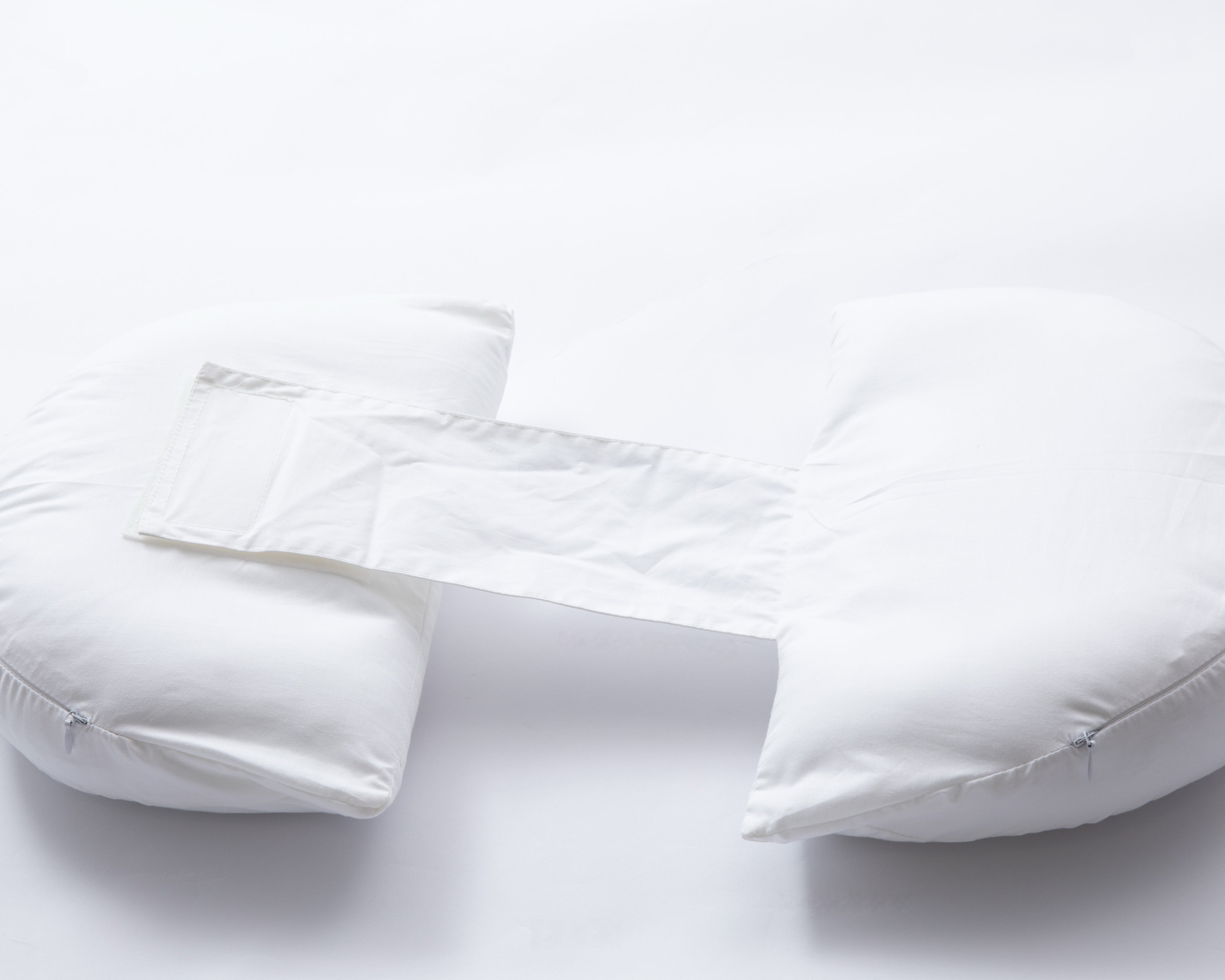 The Side Sleeping Chest Pillow, a white U-shaped breast surgery pillow with a central connecting strip for post-surgery support and separation, is shown on a plain white background.