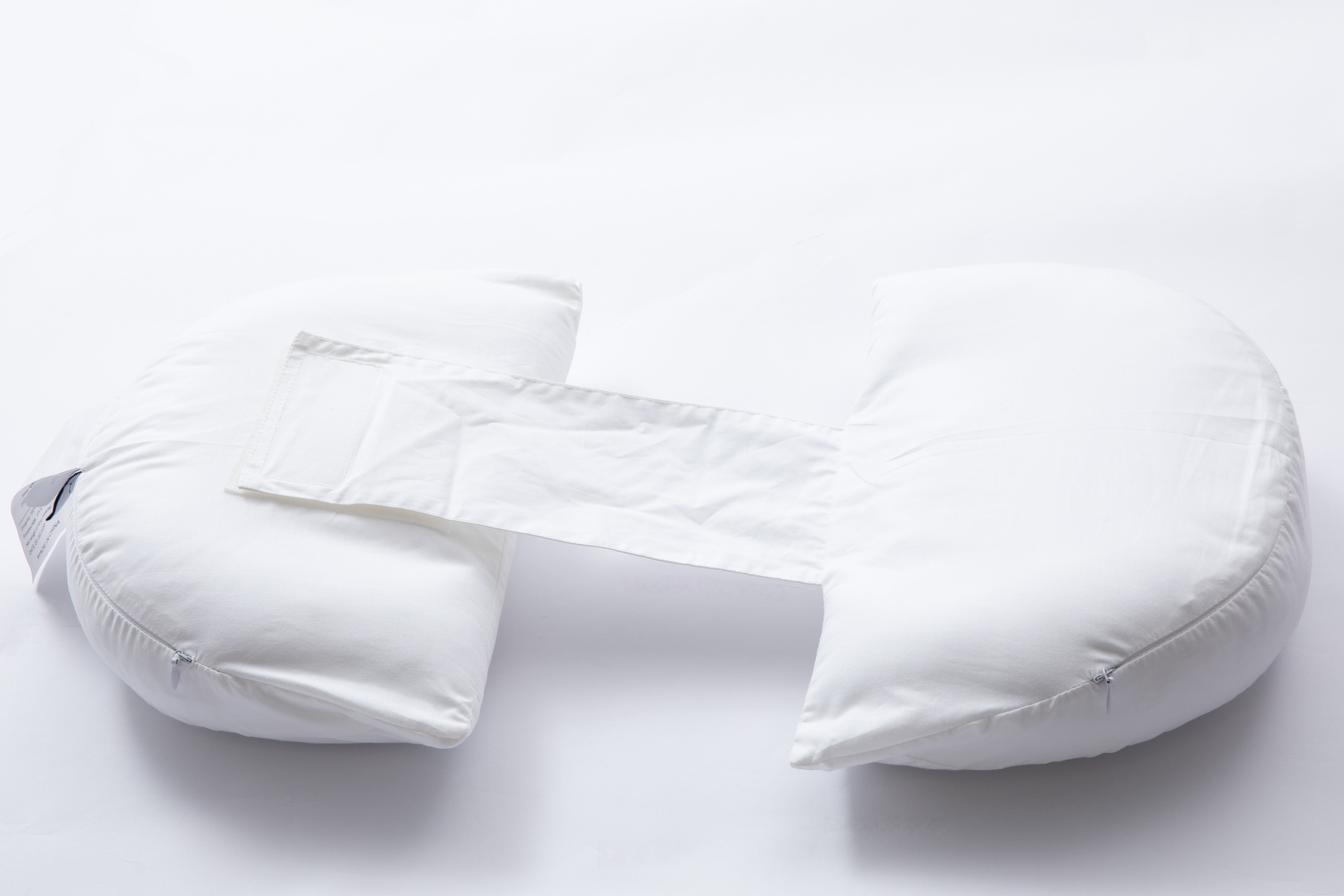 The Side Sleeping Chest Pillow, a white U-shaped breast surgery pillow with a central connecting strip for post-surgery support and separation, is shown on a plain white background.
