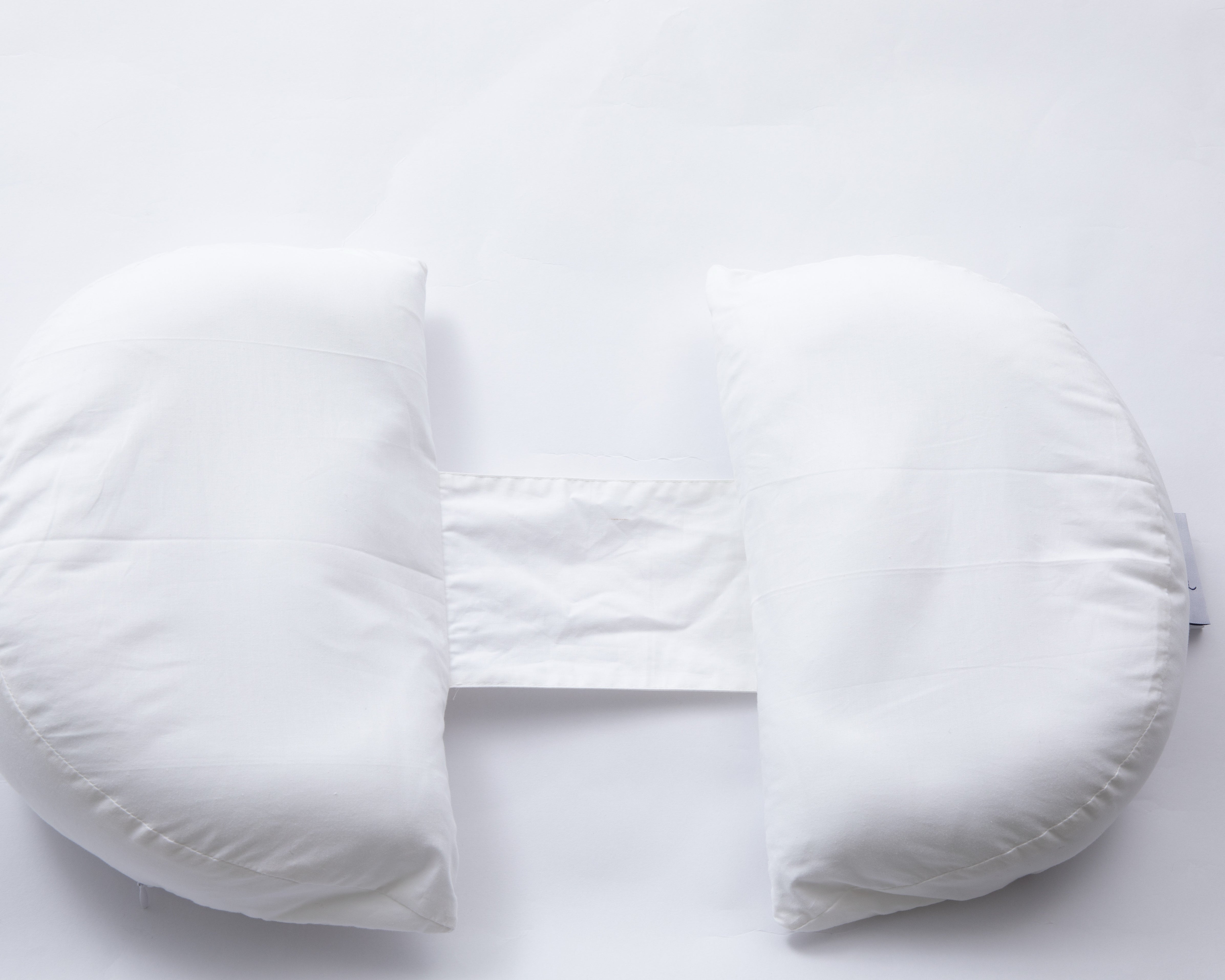 The Side Sleeping Chest Pillow is a white, U-shaped post-surgery support pillow with a fabric strap connecting the ends, shown on a plain white background.