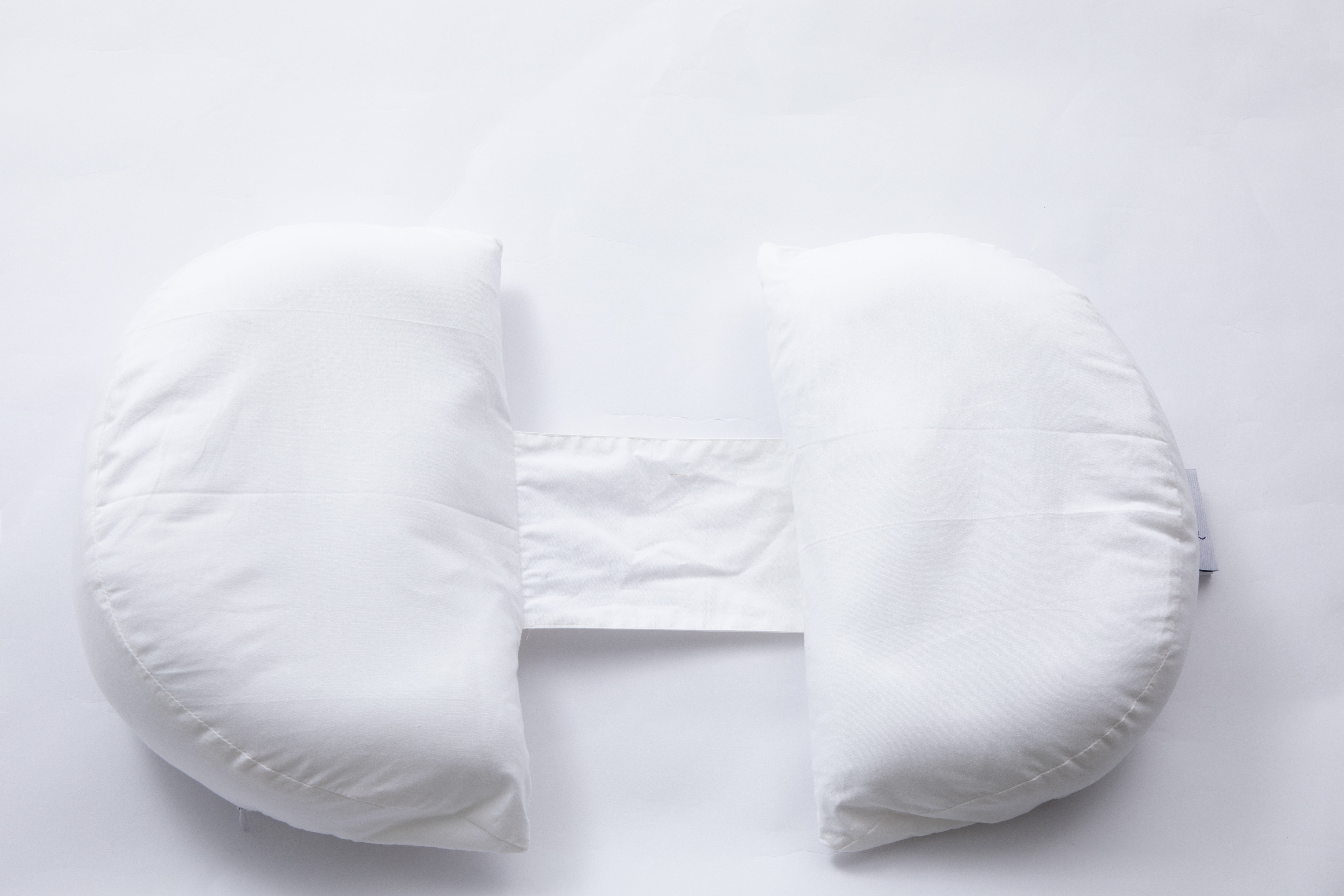The Side Sleeping Chest Pillow is a white, U-shaped post-surgery support pillow with a fabric strap connecting the ends, shown on a plain white background.