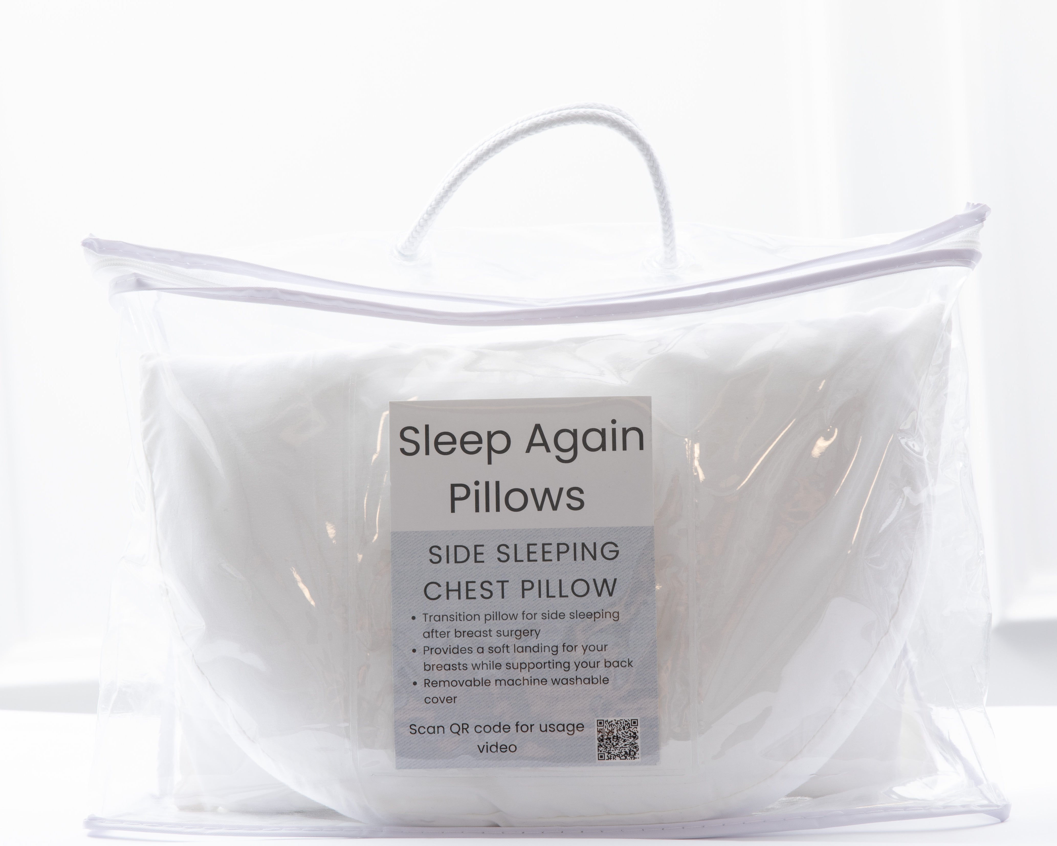 A white Side Sleeping Chest Pillow comes in a clear zippered carrying case with a handle. The front label features "Side Sleeping Chest Pillow," states it's for breast surgery, and includes usage info plus a QR code.