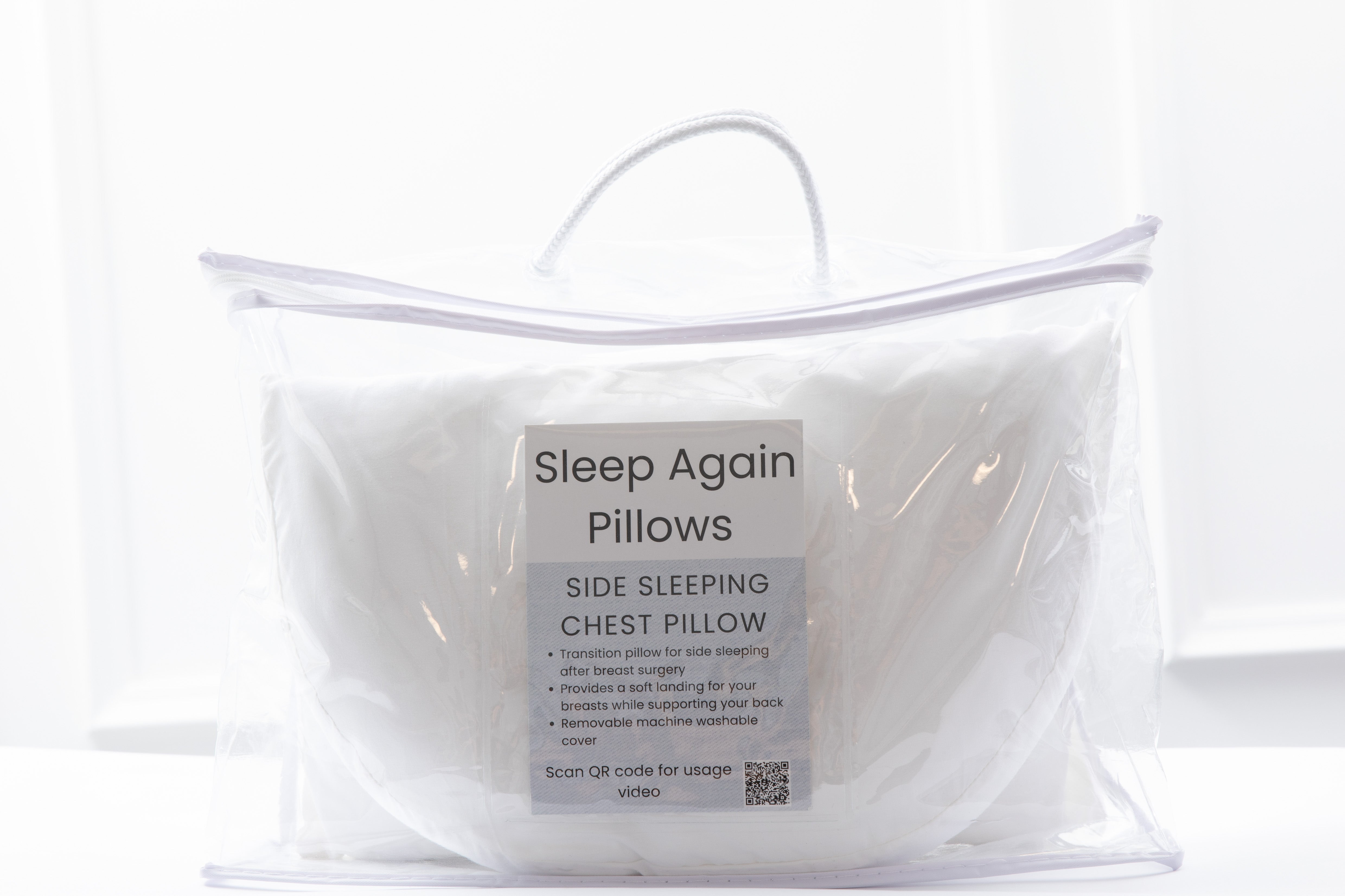 A white Side Sleeping Chest Pillow comes in a clear zippered carrying case with a handle. The front label features "Side Sleeping Chest Pillow," states it's for breast surgery, and includes usage info plus a QR code.