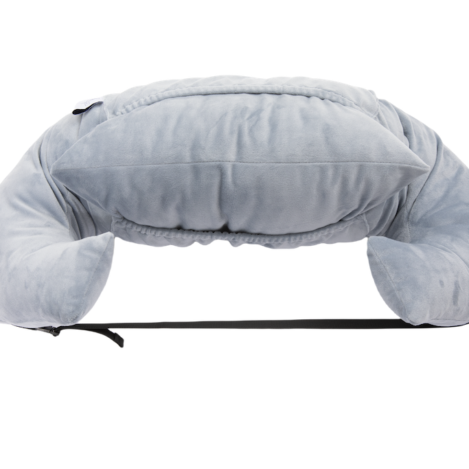 The Chest Pillow is a soft, light gray U-shaped travel pillow with extra top cushioning and a black adjustable strap, shown on a plain white background—perfect as a chest pillow for comfort after breast surgery.