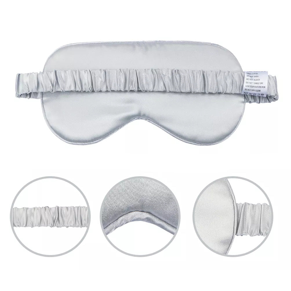 The Mulberry Silk Sleep Eye Mask with Silk Covered Elastic Strap is pictured in silver. Three circular insets show the strap, soft inner lining, and mask edge. A fabric care label is attached to this luxurious blackout mask’s strap.