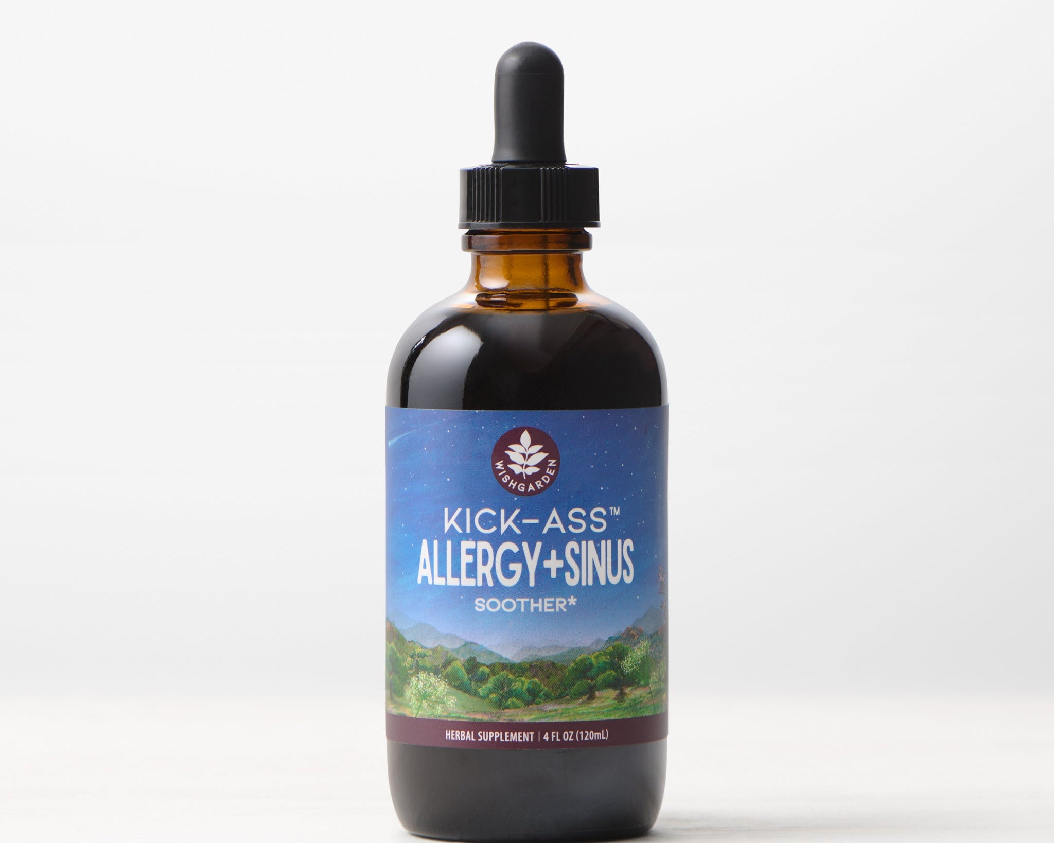 An amber glass dropper bottle labeled Kick-Ass Allergy & Sinus, Soother rests on a white surface. Its label shows mountains beneath a night sky. This 4 fl oz (120 ml) herbal supplement provides non-drowsy allergy and sinus support.