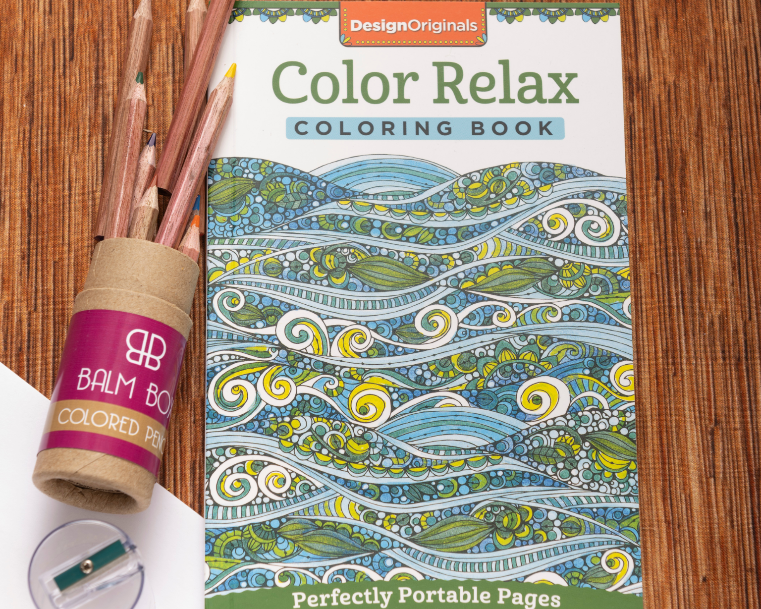 The Best Mastectomy Care Package features the Color Relax coloring book with wave designs, colored pencils in a tube, and a sharpener—ideal for bringing creativity and comfort to mastectomy recovery.