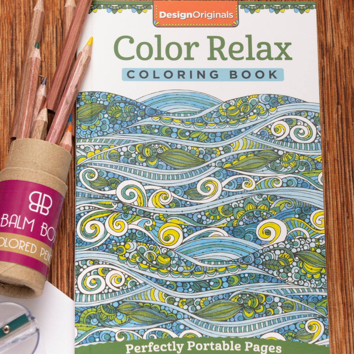 The Best Mastectomy Care Package features the Color Relax coloring book with wave designs, colored pencils in a tube, and a sharpener—ideal for bringing creativity and comfort to mastectomy recovery.