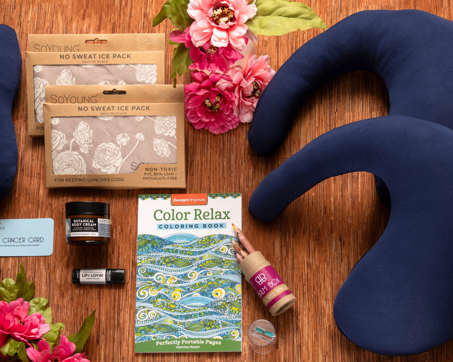 The Best Mastectomy Care Package features a post-mastectomy pillow, sleep mask, ice packs, jar candle, lip balm, flowers, coloring book, and colored glue—ideal for relaxation and self-care after surgery.