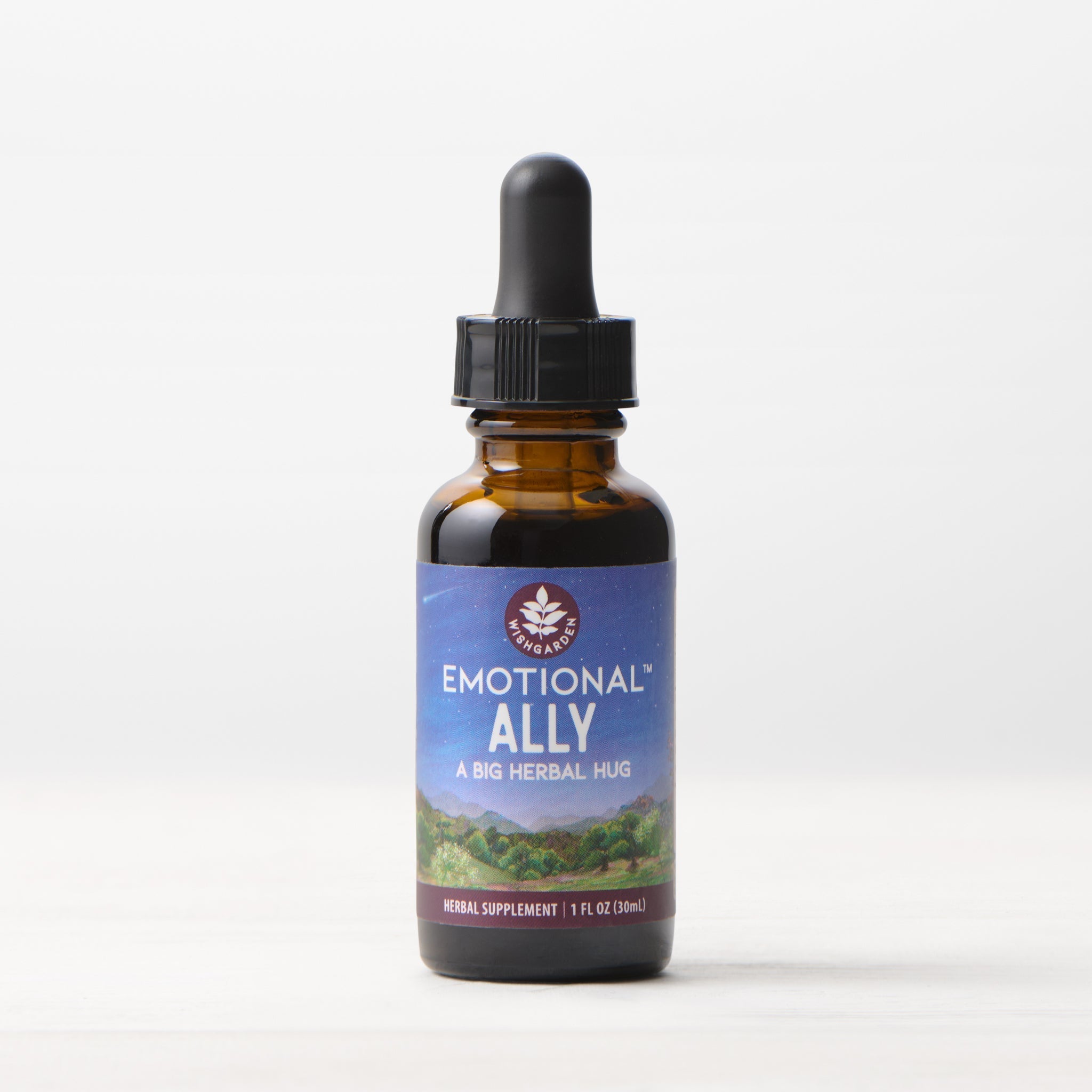 A brown glass dropper bottle labeled Emotional Ally: A Big Herbal Hug rests on a light surface with a simple background. The label, showing a nature scene, identifies this 1 fl oz herbal supplement as a blend for mood and emotional support.