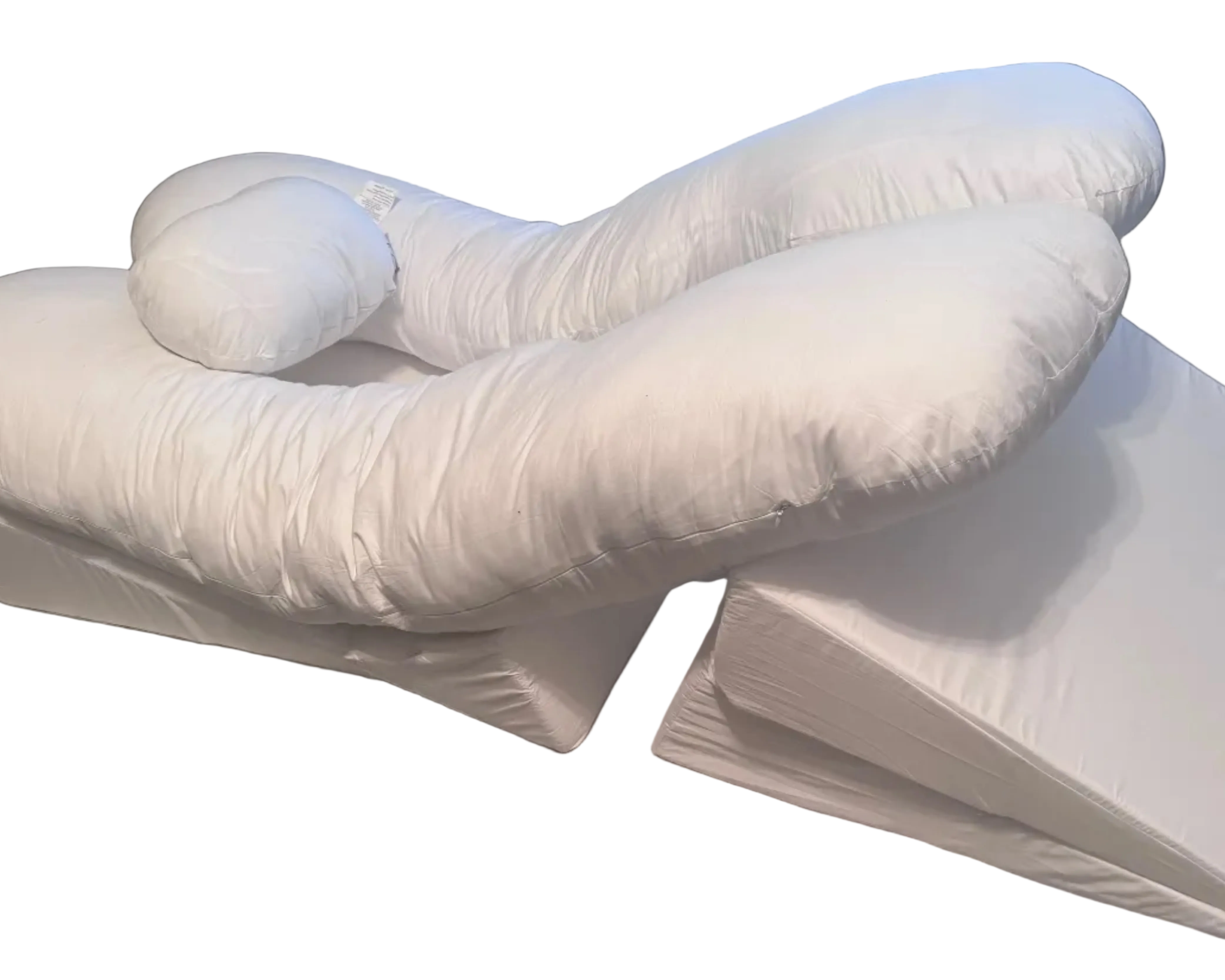 The BBL Add On Set includes a white U-shaped body pillow with an attached cylindrical neck pillow, placed atop two wedge-shaped cushions. All pieces are covered in soft white fabric—ideal for BBL recovery.