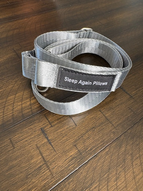 The Sleep Again Surgical Drain Holder is a gray adjustable lanyard with metal rings and a black Sleep Again Pillows patch, designed for easy and convenient post-surgery drain management.
