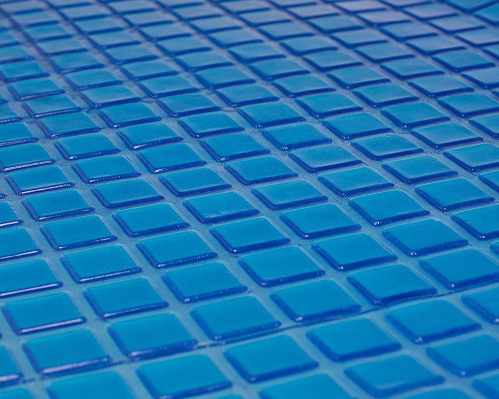 Close-up of glossy, blue square tiles arranged in a grid, evoking the soothing effect and cool tones of the Final Sale: Opulence Glacier Blanket | Cooling & Weighted for adults.