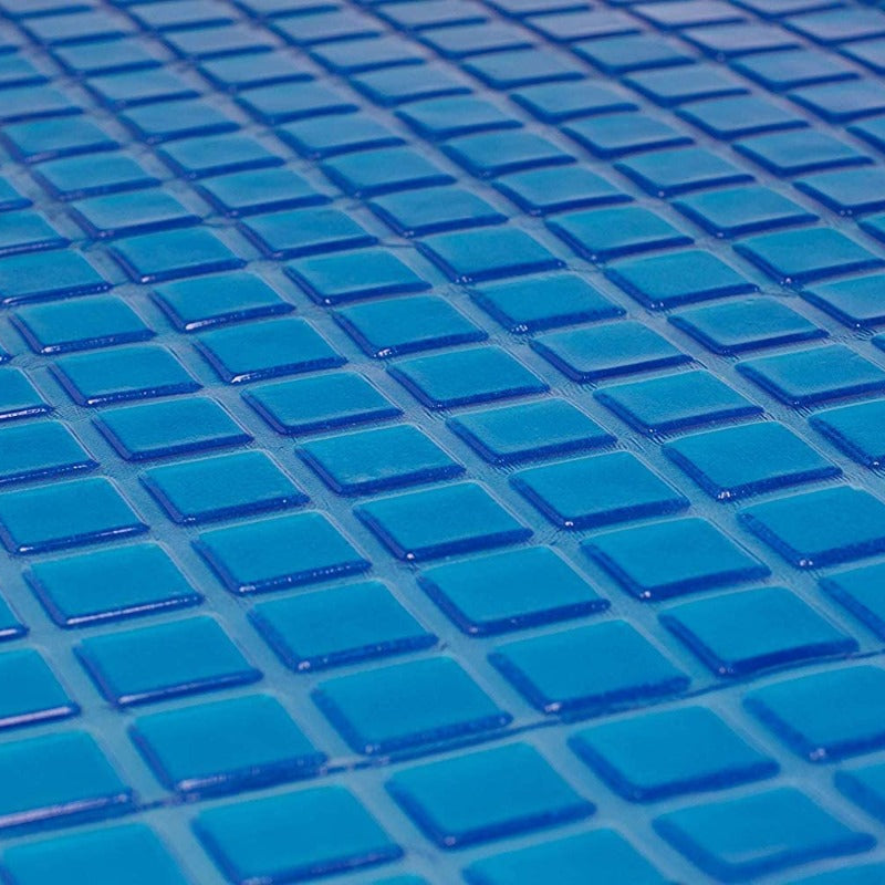 Close-up of glossy, blue square tiles arranged in a grid, evoking the soothing effect and cool tones of the Final Sale: Opulence Glacier Blanket | Cooling & Weighted for adults.