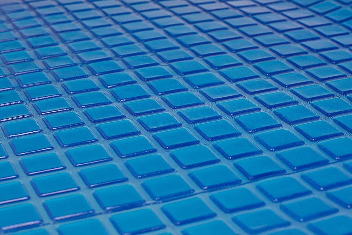 Close-up of glossy, blue square tiles arranged in a grid, evoking the soothing effect and cool tones of the Final Sale: Opulence Glacier Blanket | Cooling & Weighted for adults.