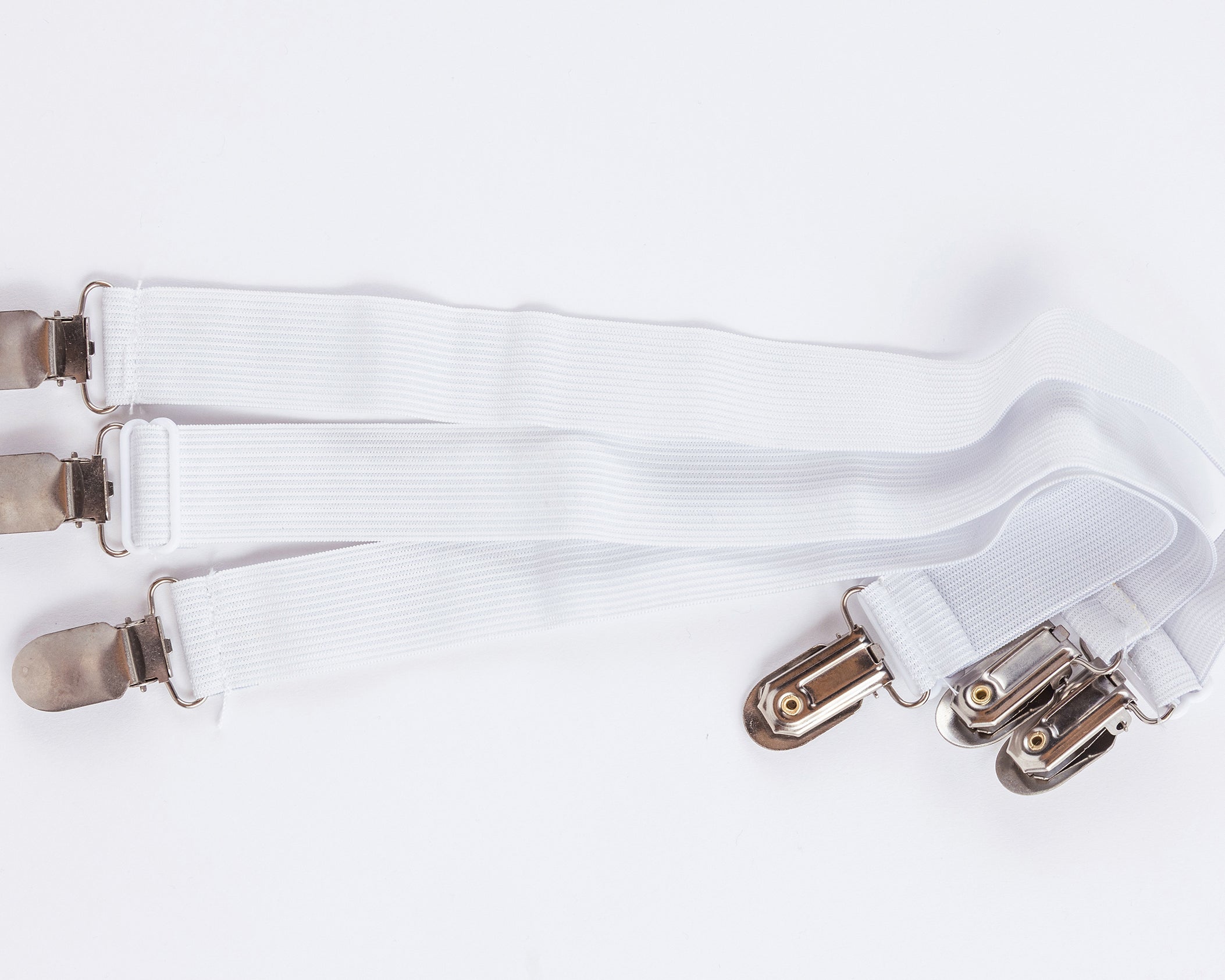 Three white elastic straps with metal clips at both ends, arranged parallel on a white background—perfect for securing Two Side Pillows Sold Separately, featuring washable slipcovers.