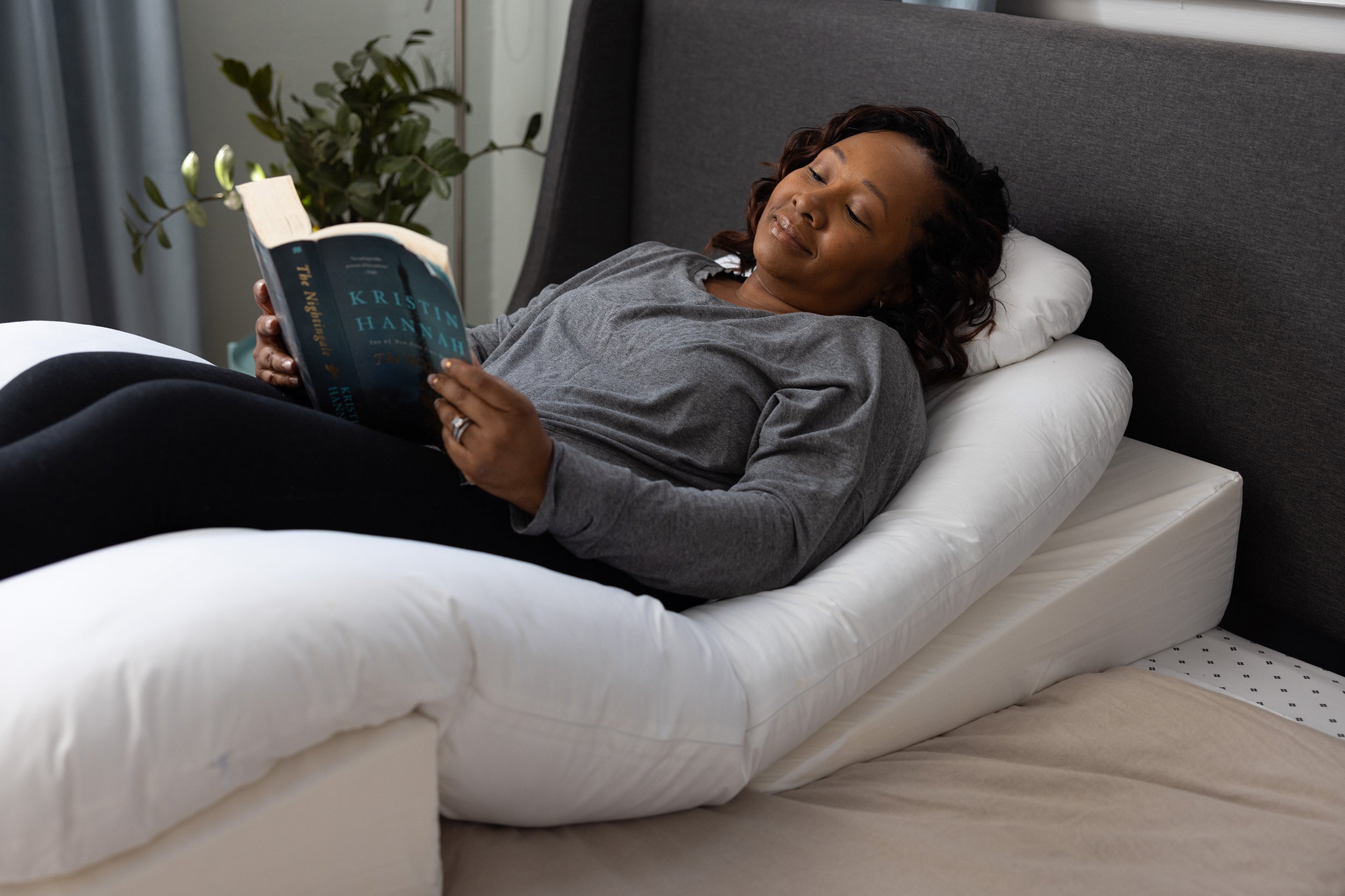 A woman sleeping on the Sleep Again Pillow System, a doctor-recommended pillow system specifically designed for mastectomy and post-surgery recovery.