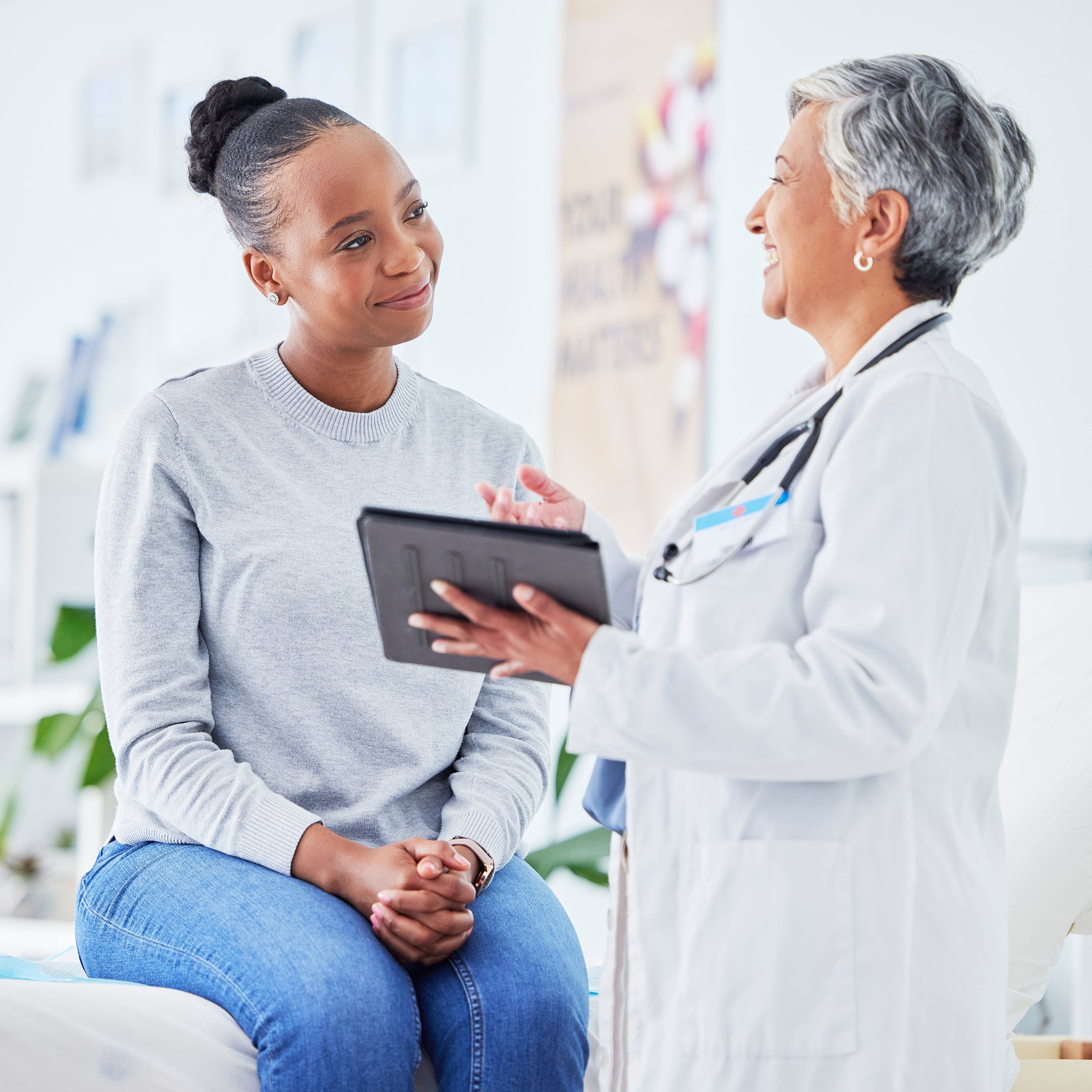 A woman consults with her doctor about her surgery. Sleep Again Pillows offers the best post-surgical pillows for mastectomy recovery, breast surgeries, general surgeries, orthopedic surgeries, and back pain.