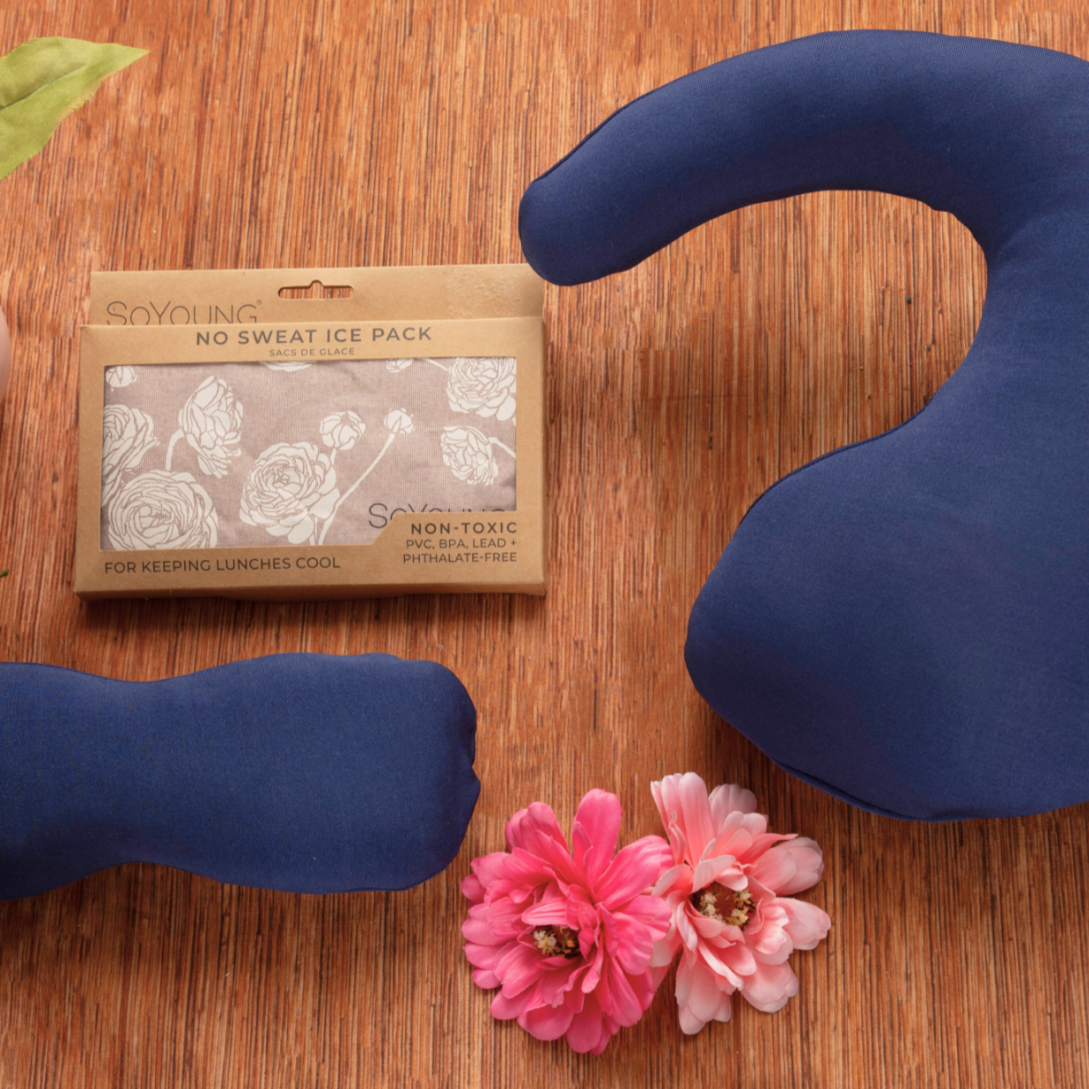 Three blue fabric ice packs in assorted shapes are shown with pink flowers and a "No Sweat Ice Pack" package—perfect for including in The Best Mastectomy Care Package or as part of a breast cancer gift box.