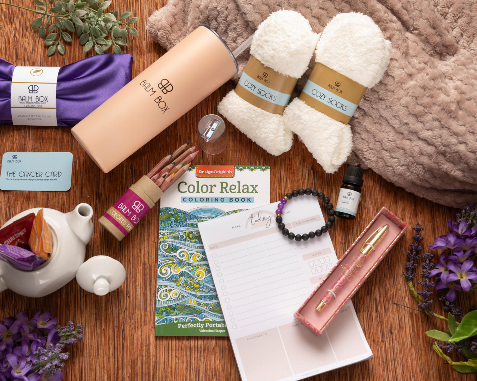 The Sweetest Rest & Recovery Box features cozy socks, a water bottle, tea, a planner, and more—thoughtfully arranged to create the perfect cancer recovery gift that encourages rest, relaxation, and comfort.