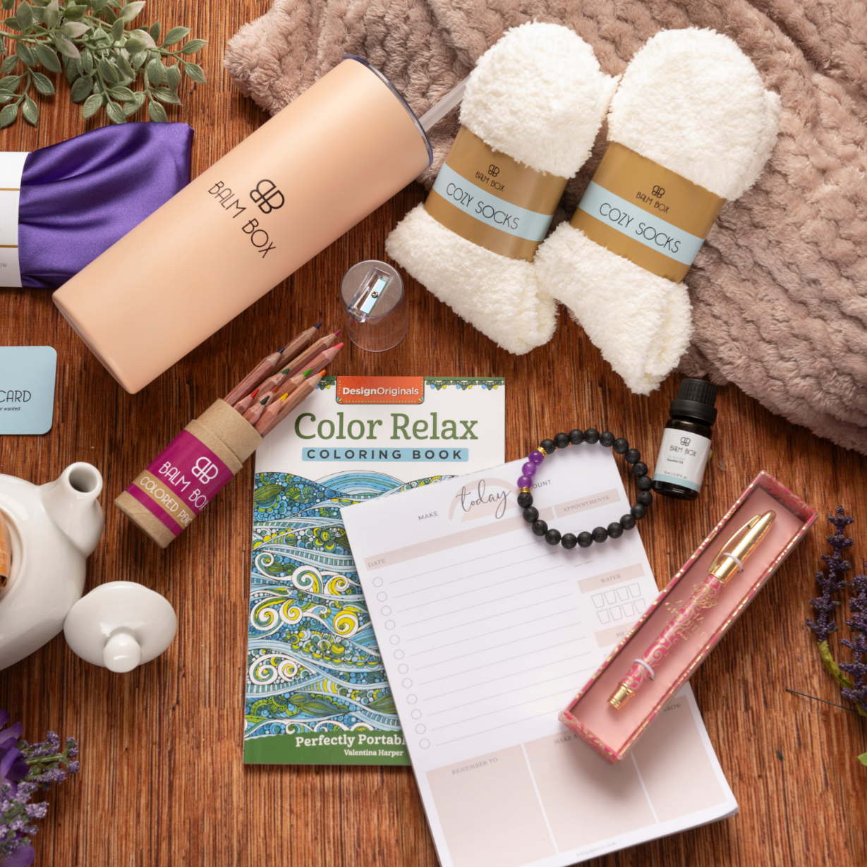 The Sweetest Rest & Recovery Box features cozy socks, a water bottle, tea, a planner, and more—thoughtfully arranged to create the perfect cancer recovery gift that encourages rest, relaxation, and comfort.