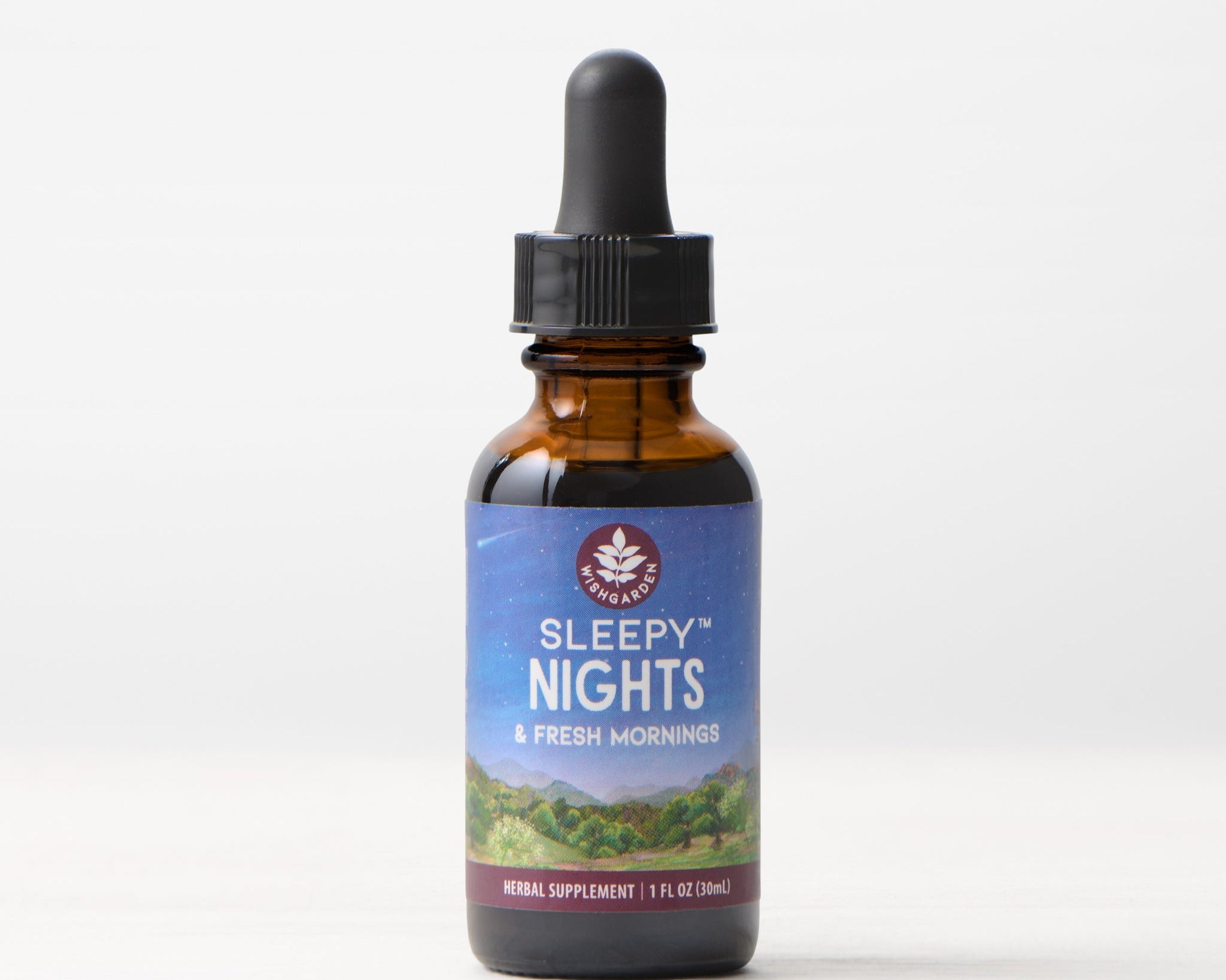A brown glass dropper bottle labeled Sleepy Nights & Fresh Mornings, 1 fl oz (30ml), sits on a pale background—an organic sleep supplement crafted with gentle herbs for restful nights without sedation.