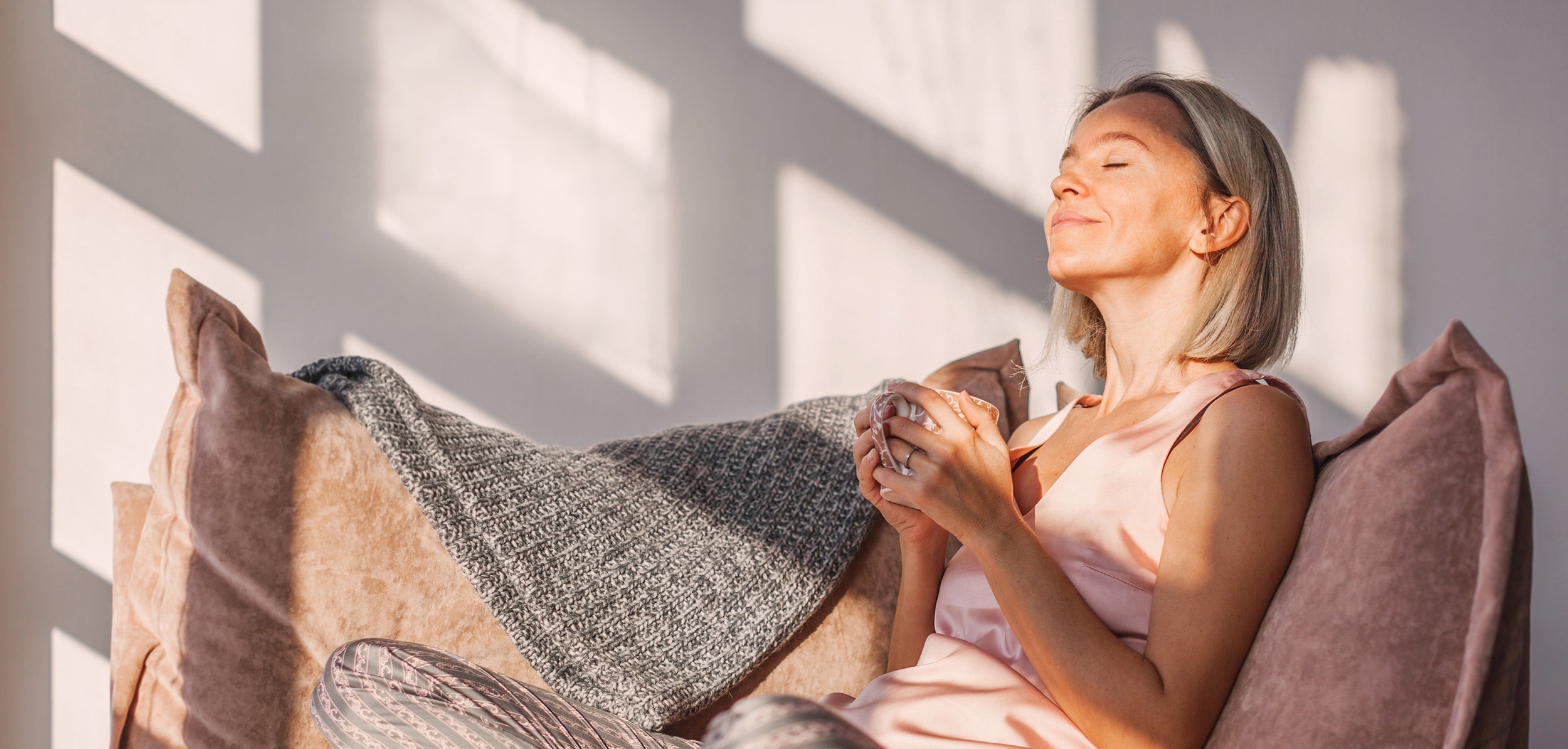 A woman breathes deep while enjoying a morning coffee. Learn how sleeping at a 30-degree angle improves digestion, breathing, circulation & pain. Science-backed benefits plus practical setup guidance.