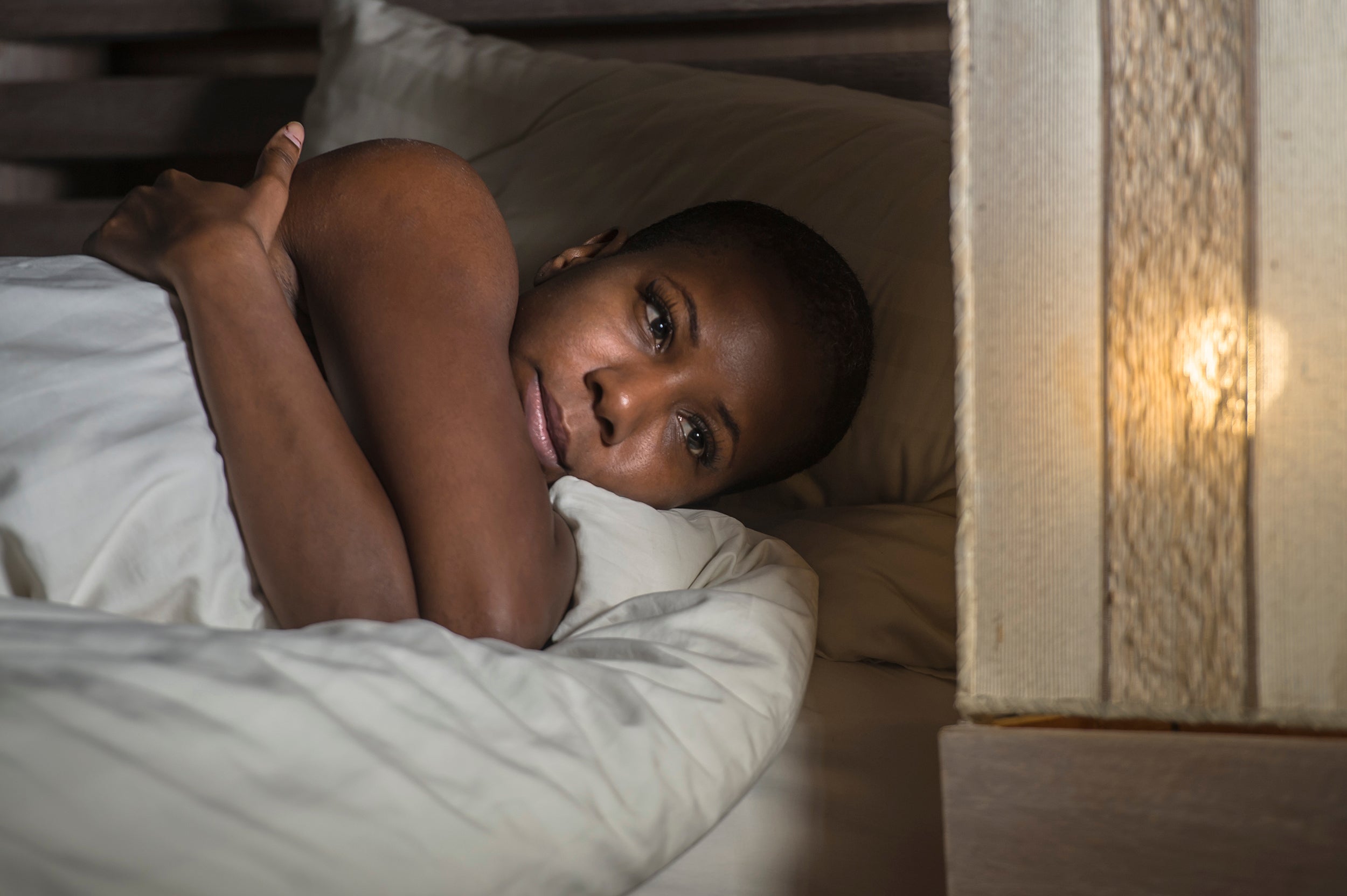 A woman struggling to sleep. Cancer treatment can disrupt sleep through surgical pain, medication side effects, and hot flashes. See the common causes and practical ways to sleep better.