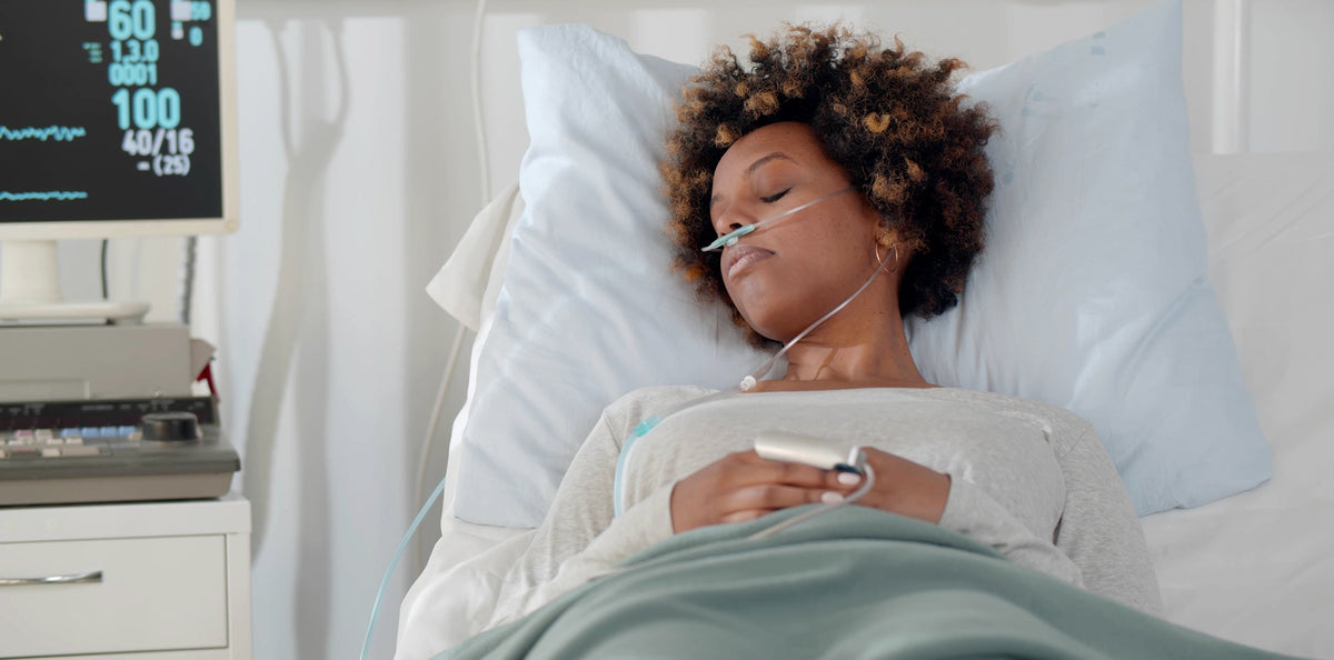 A woman sleeping in a hospital bed. Sleep position after a myomectomy affects recovery speed and nightly pain. Get timelines by surgery type, positions to avoid, and equipment that supports you.