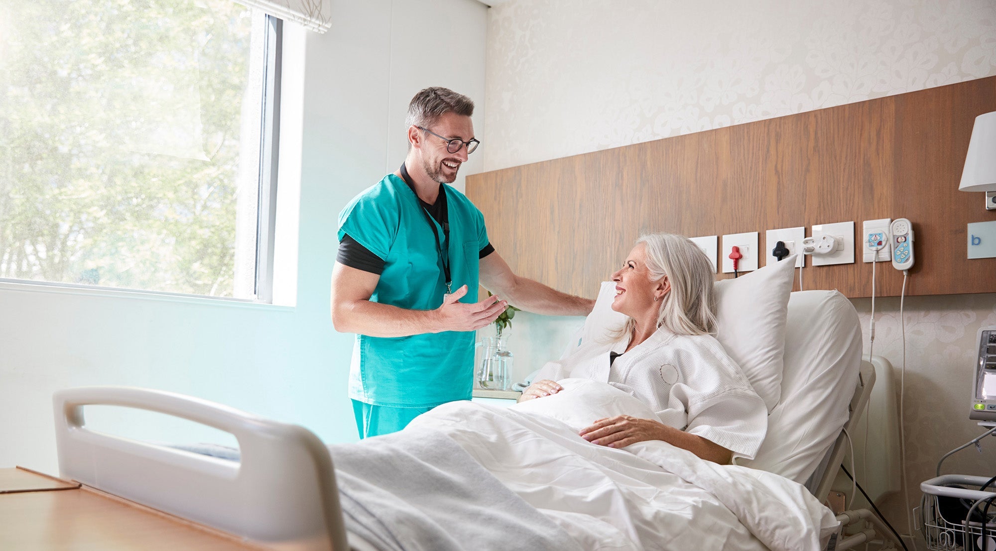 A doctor talks to a patient. Planning skin removal surgery recovery? Learn what sleep positions, timelines, and setup you need before surgery day—not after.