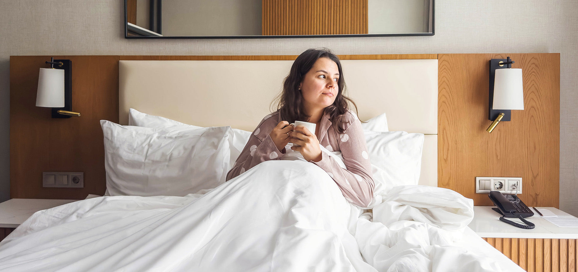 A woman sits up in bed. Getting a tummy tuck? Build your pre-op checklist now, from sleep positioning to compression garments, so recovery supplies are ready before your surgery day.