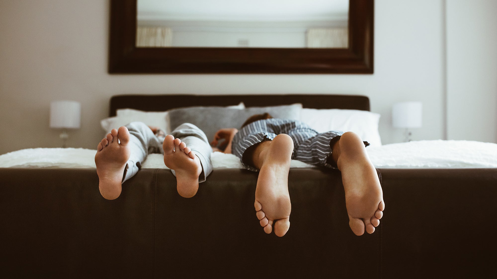 Two people sleeping in different positions. Back, side, stomach, or elevated—every sleep position affects your spine, breathing, and comfort differently. Compare the real pros and cons of each.