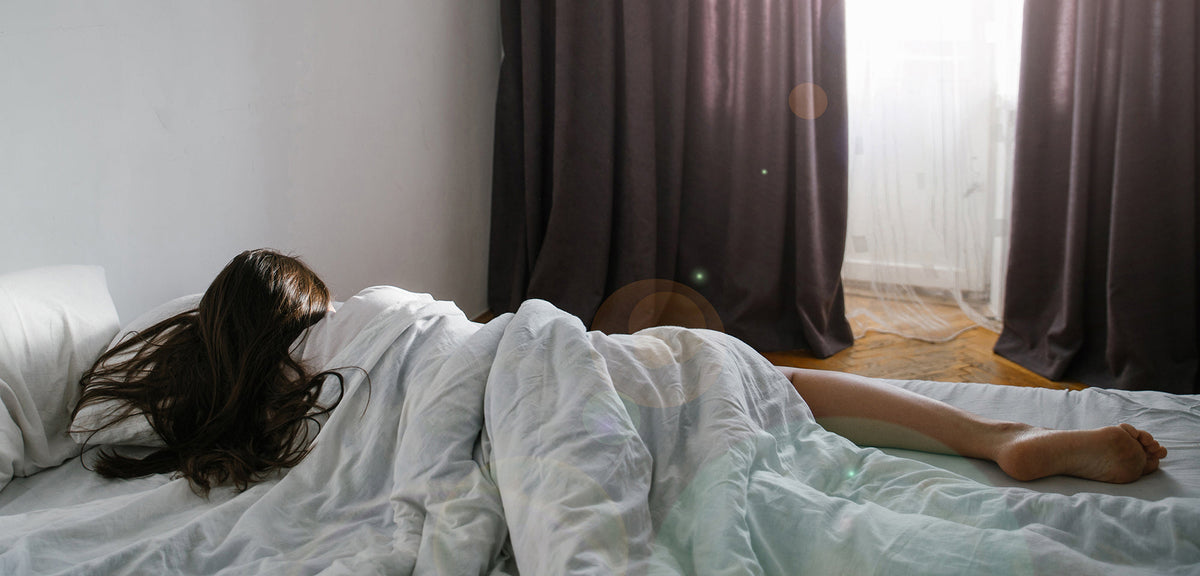 A woman sleeping on her side. Facelift recovery sleep guide: when side sleeping is safe again, why elevation matters for swelling, and how to set up positioning before your surgery day.